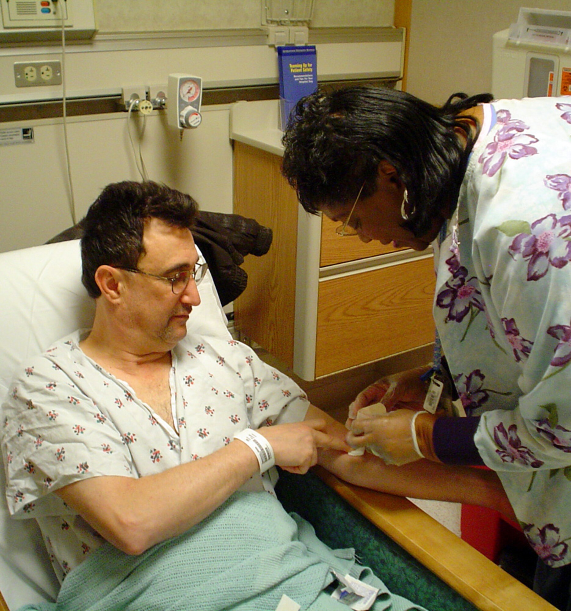 Regina Murray, a clinical technician at Georgetown University Hospital in Washington, D.C., takes blood from James Speanburg before his bone marrow surgery Friday, March 24, 2006. Mr. Speanburg was identified as a marrow match for a 10-year-old boy with severe aplastic anemia. Mr. Speanburg is a certified pharmacy technician with the 22nd Medical Support Squadron at McConnell Air Force Base, Kan. (U.S. Air Force photo)