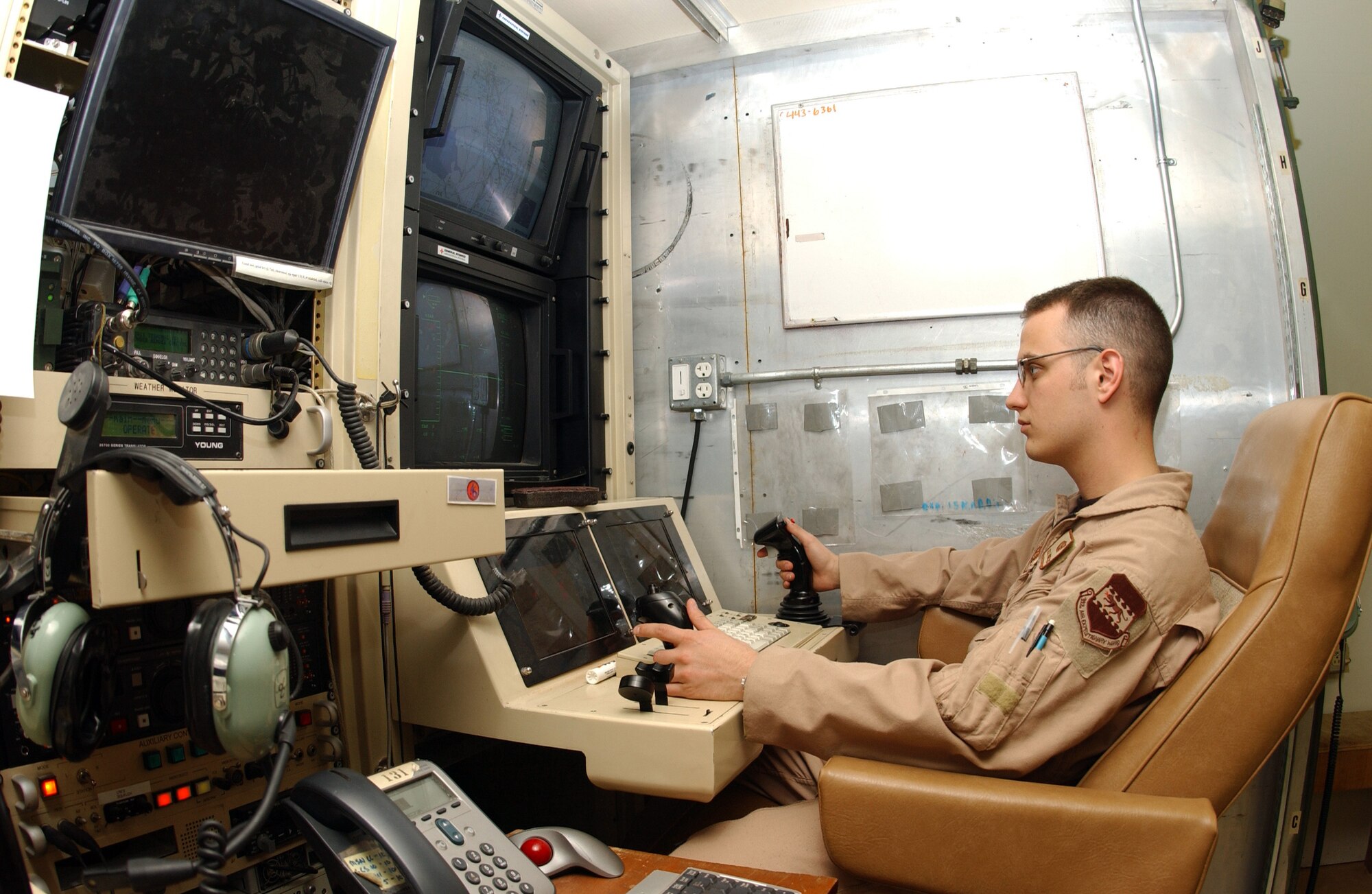 Airman 1st Class Kyle Bridges sits in the sensor operator's chair at an RQ-1 Predator Unmanned Aerial Vehicle ground control station at Balad Air Base, Iraq. (U.S. Air Force photo) 