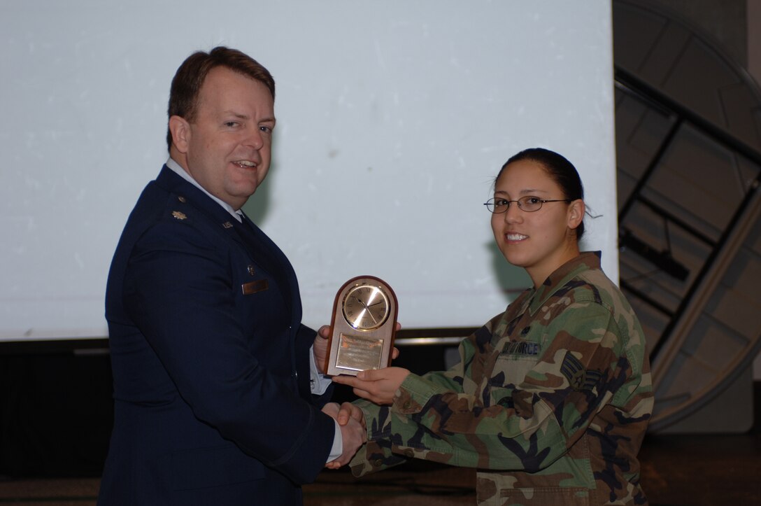 Senior Airman Ashlee Huver (right), 422nd Communications Squadron, accepts her award as 422nd Communications Squadron Airman of the Year from Lt. Col. George Lamont, 422nd CS commander.