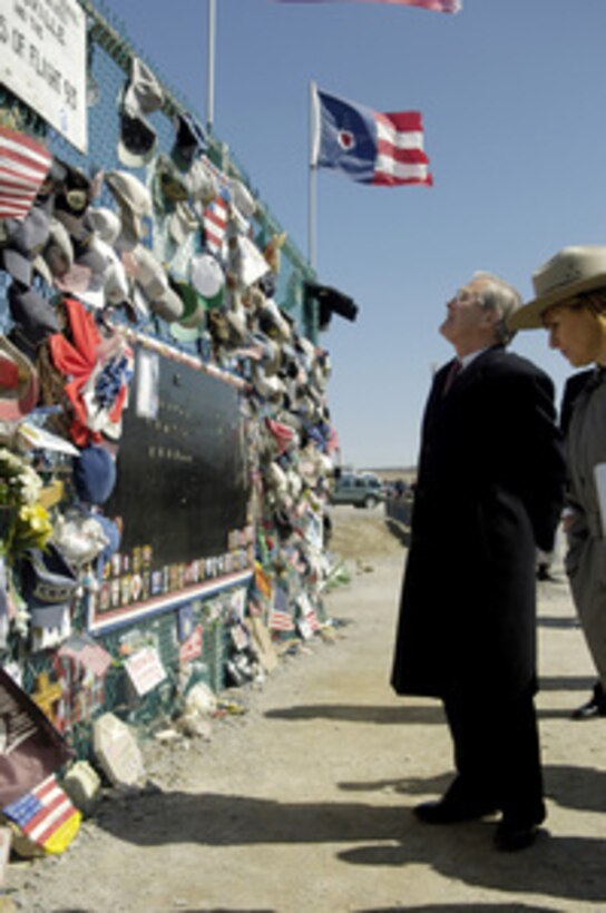 Secretary of Defense Donald H. Rumsfeld views mementoes placed at an informal memorial at the site of the Flight 93 National Memorial in Shanksville, Pa., on March 27, 2006. A memorial is being built to commemorate the victims that lost their lives overtaking a terrorist hijacked airplane and saving the plane from continuing its mission on Sept. 11, 2001. Rumsfeld was in Shanksville to visit the Flight 93 National Memorial and then continue on to the Army War College in Carlisle, Pa. 