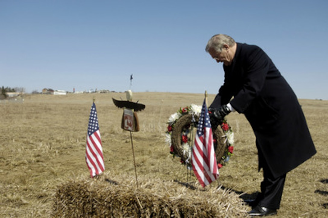 Secretary of Defense Donald H. Rumsfeld lays a wreath at the crash site of United Airlines Flight 93 in Shanksville, Pa., on March 27, 2006. A memorial is being built to commemorate the victims that lost their lives overtaking a terrorist hijacked airplane and saving the plane from continuing its mission on Sept. 11, 2001. Rumsfeld was in Shanksville to visit the Flight 93 National Memorial and then continue on to the Army War College in Carlisle, Pa. 
