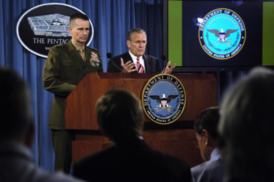 Secretary of Defense Donald H. Rumsfeld gestures to make a point as he answers a reporter's question during a Pentagon press briefing with Chairman of the Joint Chiefs of Staff Gen. Peter Pace, U.S. Marine Corps, in Arlington, Va., on March 28, 2006. Rumsfeld spoke of his trip to the crash site of United Flight 93 on Sept. 11, 2001, in Shanksville, Pa., in his opening remarks before he and Pace took questions from reporters. 