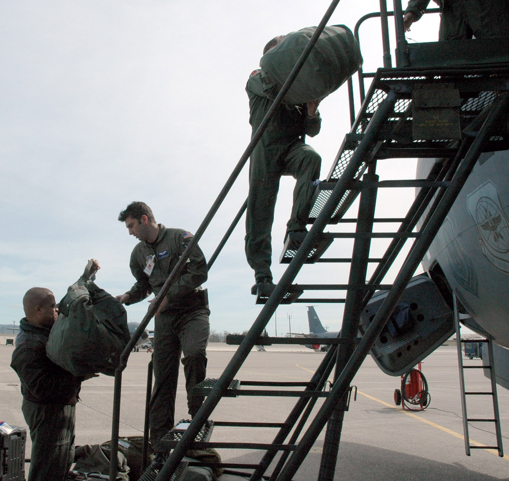 Senior Master Sgt. Michael Davis, Command KC-145 evaluator boom operator, Headquarters Air Mobility Command, Staff Sgt. Jared Wahleithner, air refueling boom operator, 314th Air Refueling Squadron and Maj. Paul Sheehan, piolot, 314 ARS, load mobility bags onto a KC-135 during an exercise March 4 at Beale Air Force Base, Calif.  (U.S. Air Force photo by Tech. Sgt. Brynna Bryant)