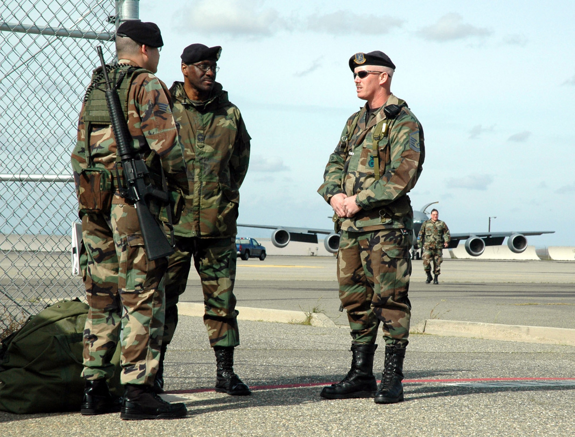 Senior Airman Steven Clayton, fire team member, 940th Security Forces, Chief Master Sgt. Danny Shine, security forces staff assistance visit lead, Headquarters Air Mobility Command and Master Sgt. Daniel Fode, flight cheif, 940 SFS, discuss security procedures during an exercise March 4 on the flightline at Beale Air Force Base, Calif.  (U.S. Air Force photo by Brynna Bryant)