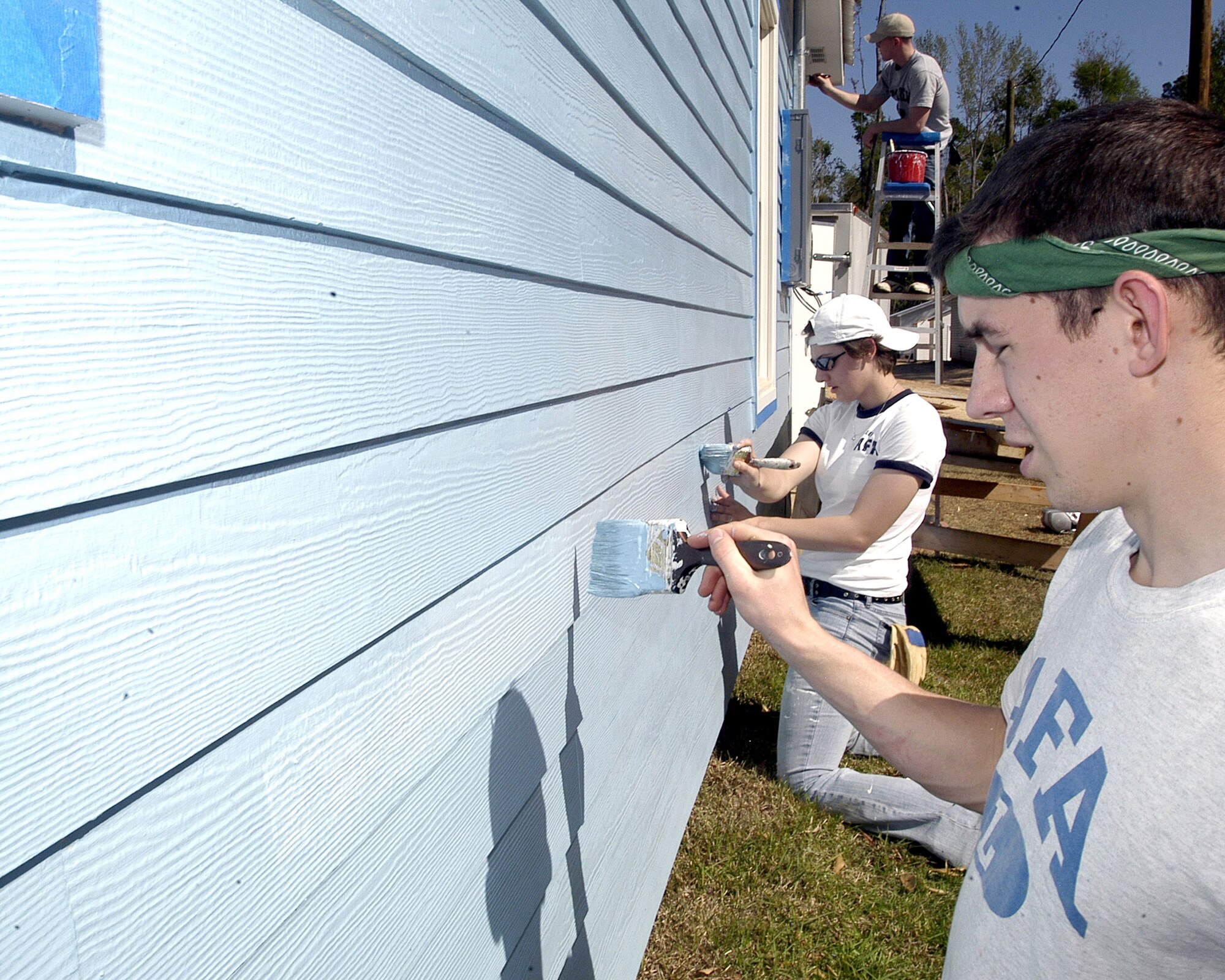Cadet 3rd Class Cory Pilinko and Cadet 4th Class Ariana Allen from the Air Force Academy work with Habitat for Humanity in Covington, La., to finish painting a newly constructed house, Monday, March 27, 2006. Approximately 140 cadets volunteered their spring break to help rebuild the disaster-struck area in Biloxi, Miss., and surrounding cities. (U.S. Air Force photo/Tech. Sgt. Brian M. Boisvert)