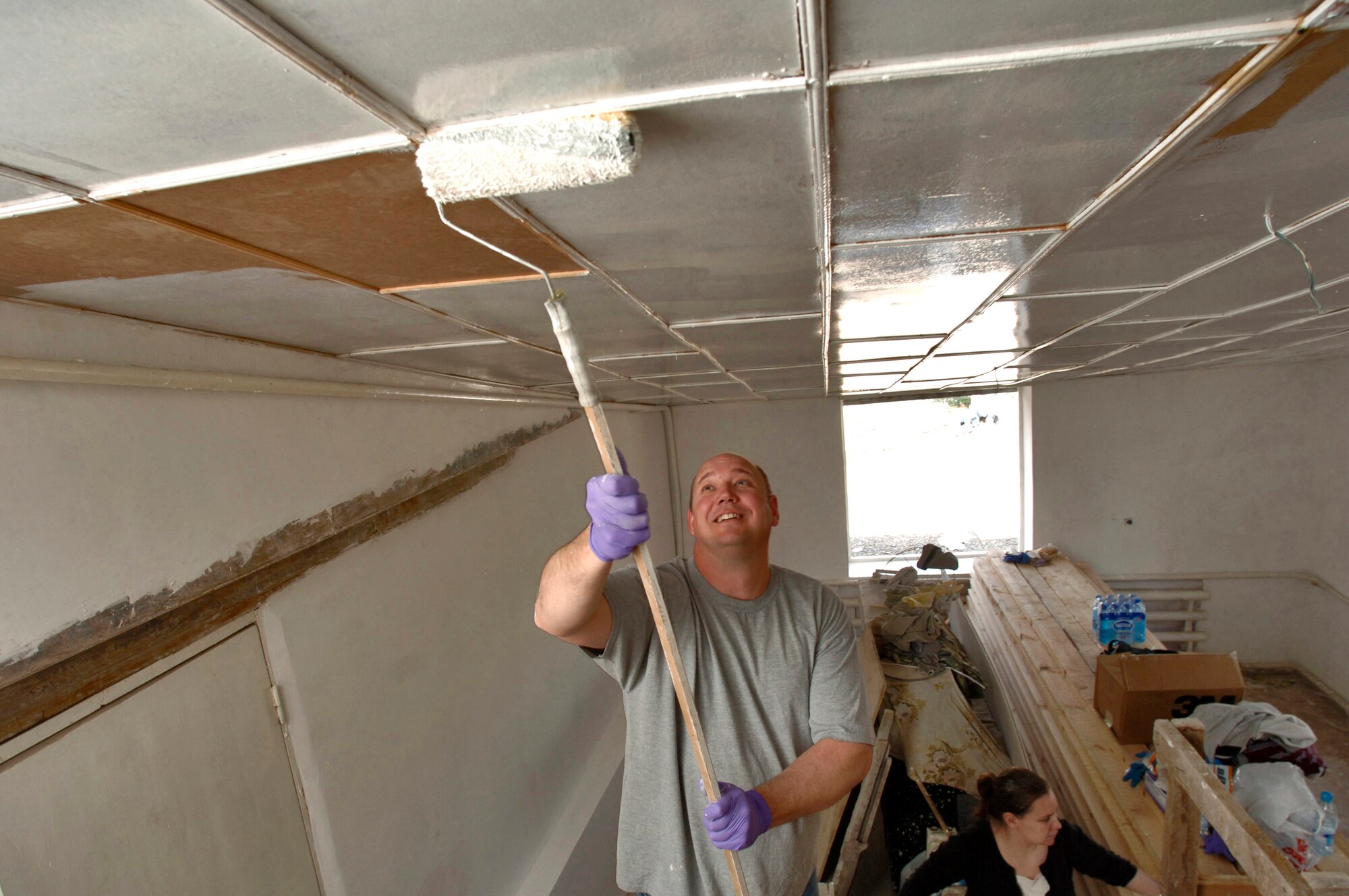 Master Sgt. Brad Bush applies the first coat of paint on the ceiling of what will be a reception room. The Devine, Texas, native is deployed to the 376th Expeditionary Logistics Readiness Squadron from the 509th Bomb Wing, Whiteman Air Force Base, Mo. (U.S. Air Force photo/Master Sgt. Lance Cheung) 