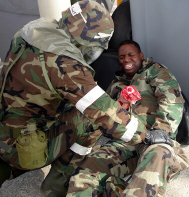 Members of the 482nd Fighter Wing played “victim” as Post-Attack Recon teams evacuated the wounded for triage while wearing biological and chemical agent protective gear.   Here Tech. Sgt. Rueal Butler, 482nd Services Squadron, receives self aid buddy care from a PAR team member (U.S. Air Force Reserve photo by Jake Shaw)