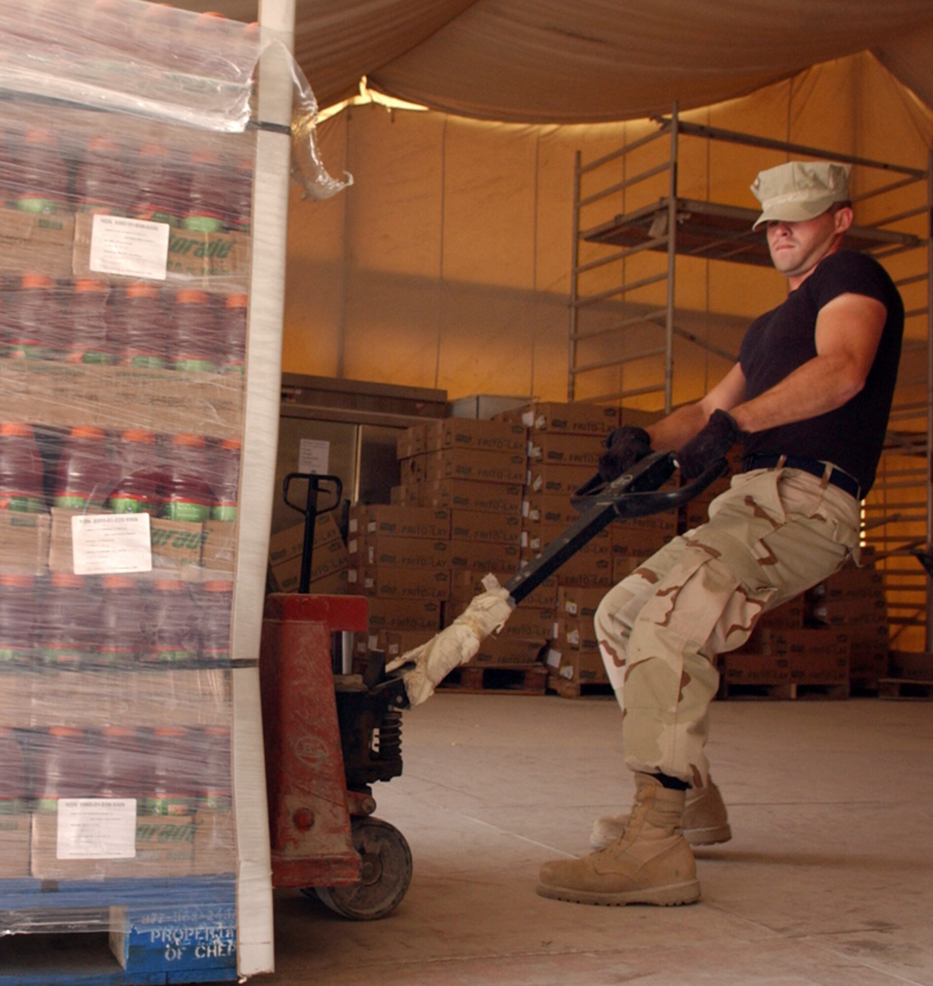 Airman 1st Class Shay Daugherty hauls a pallet of sports drinks to unload at a forward-deployed location Thursday, March 23, 2006. Airman Daugherty is with the 379th Expeditionary Services Squadron. (U.S. Air Force photo/Senior Airman Rachel Walters)


