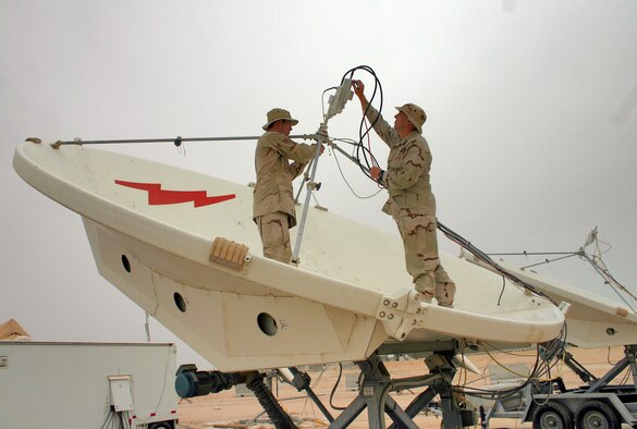 Staff Sgt. Neil Holdren and Capt. Kevin Mahar accomplish a periodic maintenance inspection on an antenna feed. The space technicians are deployed to the 379th Air Expeditionary Wing. (U.S. Air Force photo/Staff Sgt. Melissa Koskovich) 
