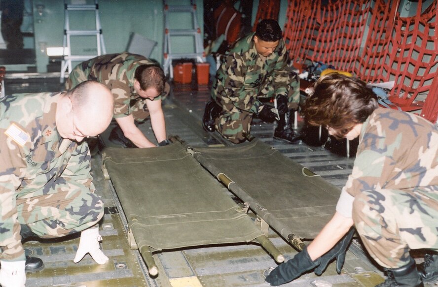 BROOKS CITY BASE, Texas  - Students enrolled in the U.S. Air Force School of Aerospace Medicine's flight nurse/aeromedical evacuation course learn to secure litters aboard a C-130. The course is unique, in that it includes different branches of service in a joint training environment. (Air Force photo by Rudy Purificato)

