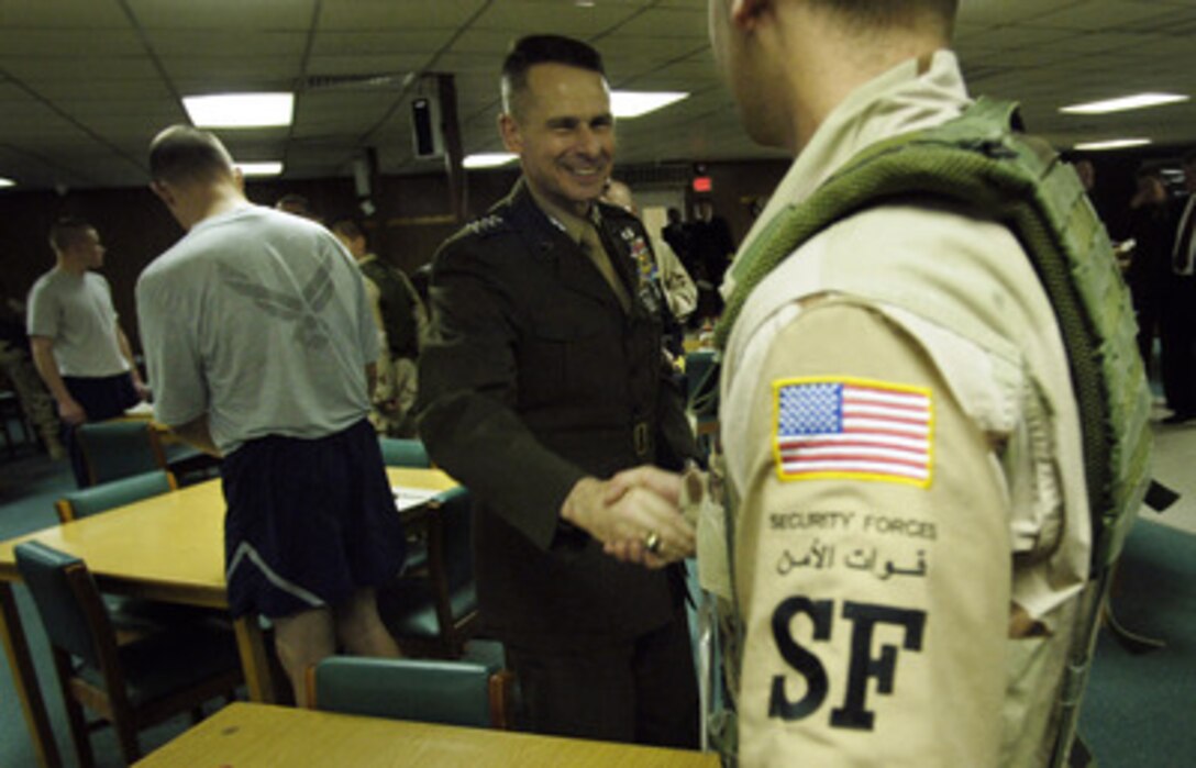 Chairman of the Joint Chiefs of Staff Gen. Peter Pace, U.S. Marine Corps, shakes hands with an airman during a visit to Eskan Village, Saudi Arabia, on March 22, 2006. Pace is in Saudi Arabia to confer with civilian and military leaders and to meet some of the troops deployed there. 