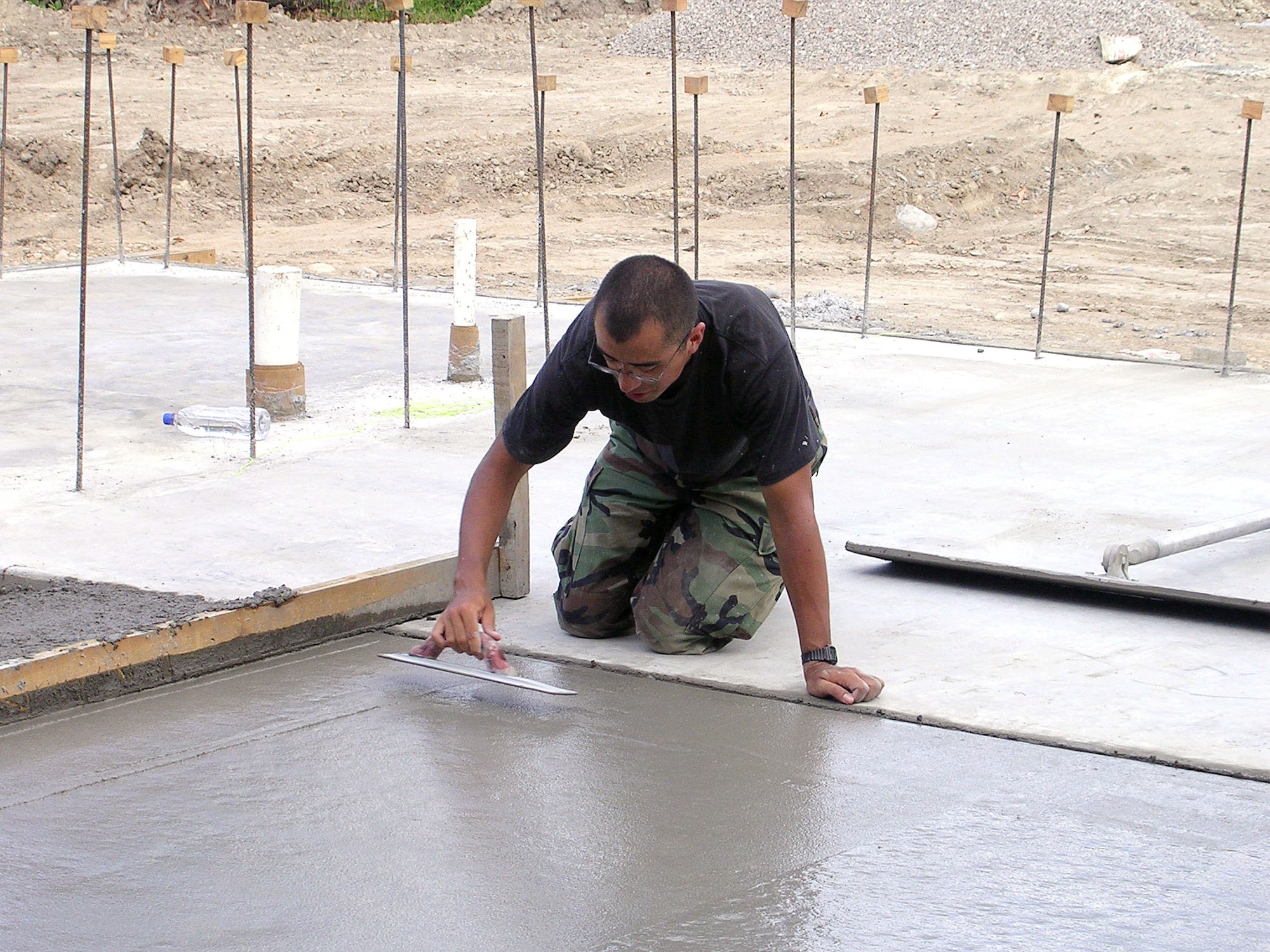 Airman 1st Class Thomas Sylvester smoothes the El Cacao school's concrete foundation.  Airman Sylvester is among 17 Airmen deployed from the 354th Civil Engineer Squadron at Eielson Air Force Base, Alaska, in support of New Horizons 2006-Honduras. The 354th is building a three-classroom school in the small village of El Cacao.  (U.S. Air Force photo/ 2nd Lt. Sean Stapler)
