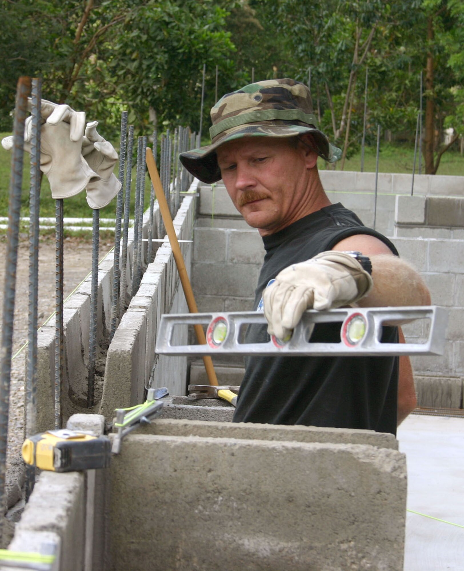 Senior Master Sgt. Mike Miller makes sure all concrete blocks are straight and level at the El Cacao school site.  Sergeant Miller is one of 17 members deployed from the 354th Civil Engineer Squadron at Eielson Air Force Base, Alaska, to build a three-classroom school in the small village of El Cacao, Honduras, as part of New Horizons 2006-Honduras.  (U.S. Air Force photo/Capt. Mike Chillstrom)
