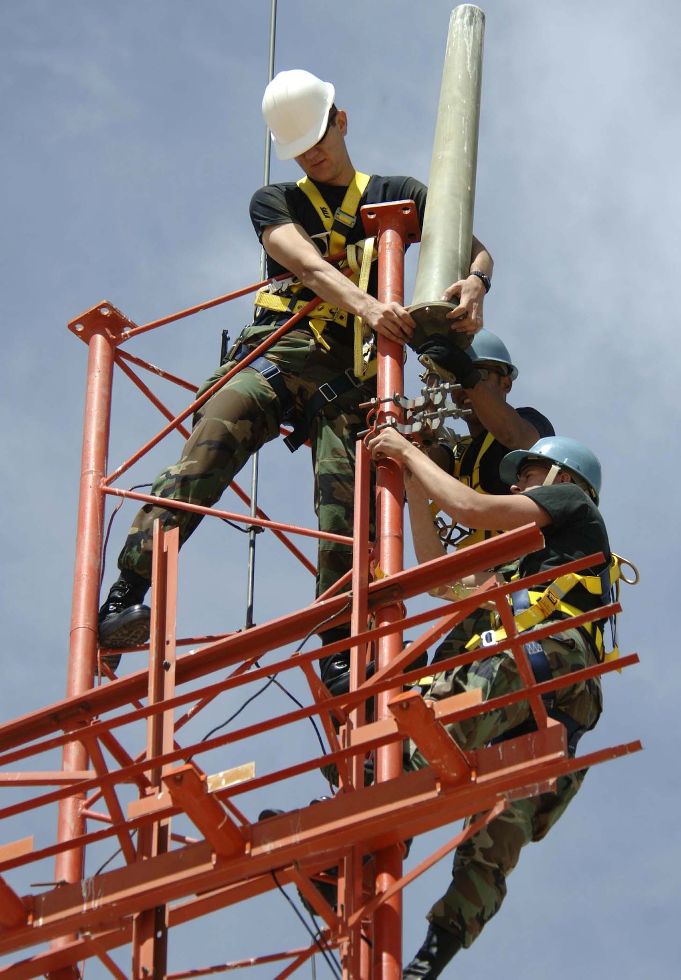 Airmen mount an AS-1181 antenna to the Glideslope antenna tower Wednesday, March 29, 2006, at Davis-Monthan Air Force Base, Ariz. The antenna was remounted to comply with lightning protection standards. It connects a very high frequency radio with the flight check office, which verifies calibration and alignment of airfield navigational equipment. The Airmen are airfield systems journeymen with the 355th Communications Squadron. (U.S. Air Force photo/Senior Airman Christina D. Ponte)