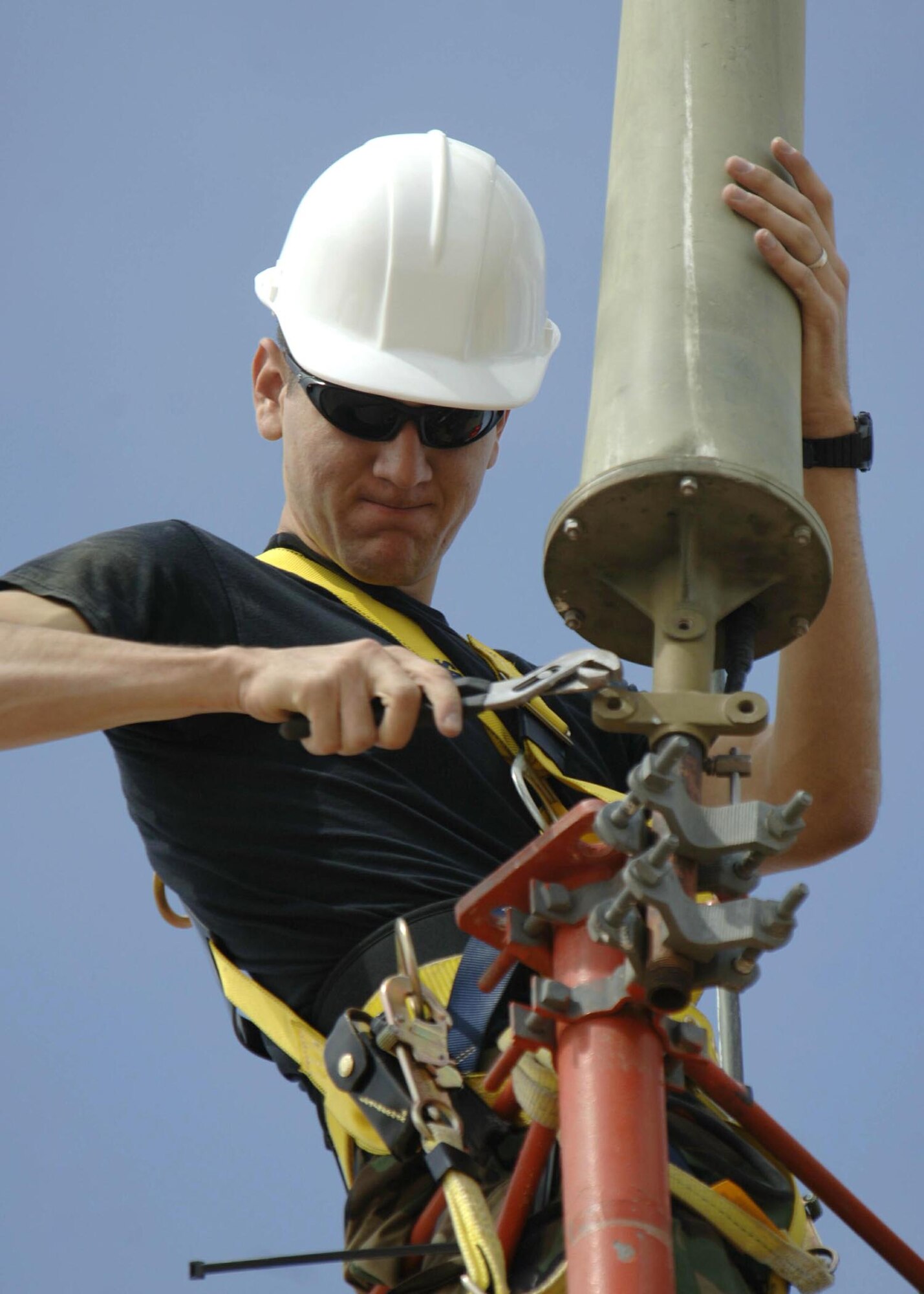 Senior Airman Scott Ponte mounts an AS-1181 antenna to the Glideslope antenna tower Wednesday, March 29, 2006 at Davis-Monthan Air Force Base, Ariz. The antenna was remounted to comply with lightning protection standards. It is used to connect a very high frequency radio with the flight check office, to verify calibration and alignment of airfield navigational equipment. Airman Ponte is an airfield systems journeyman with the 355th Communications Squadron.  (U.S. Air Force photo/Senior Airman Christina D. Ponte)