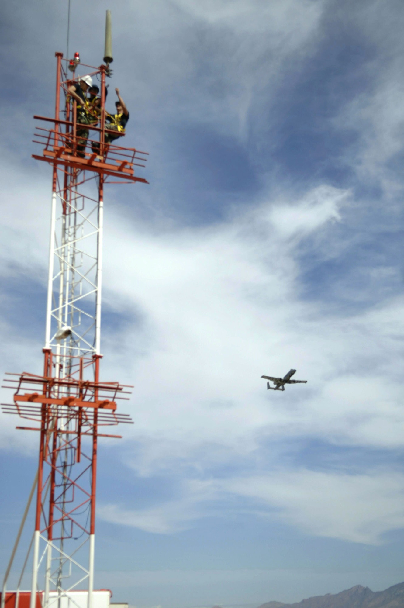 Airmen mount an AS-1181 antenna to the Glideslope antenna tower Wednesday, March 29, 2006, at Davis-Monthan Air Force Base, Ariz. The antenna was remounted to comply with lightning protection standards. It connects a very high frequency radio with the flight check office, which verifies calibration and alignment of airfield navigational equipment. The Airmen are airfield systems journeymen with the 355th Communications Squadron. (U.S. Air Force photo/Senior Airman Christina D. Ponte)