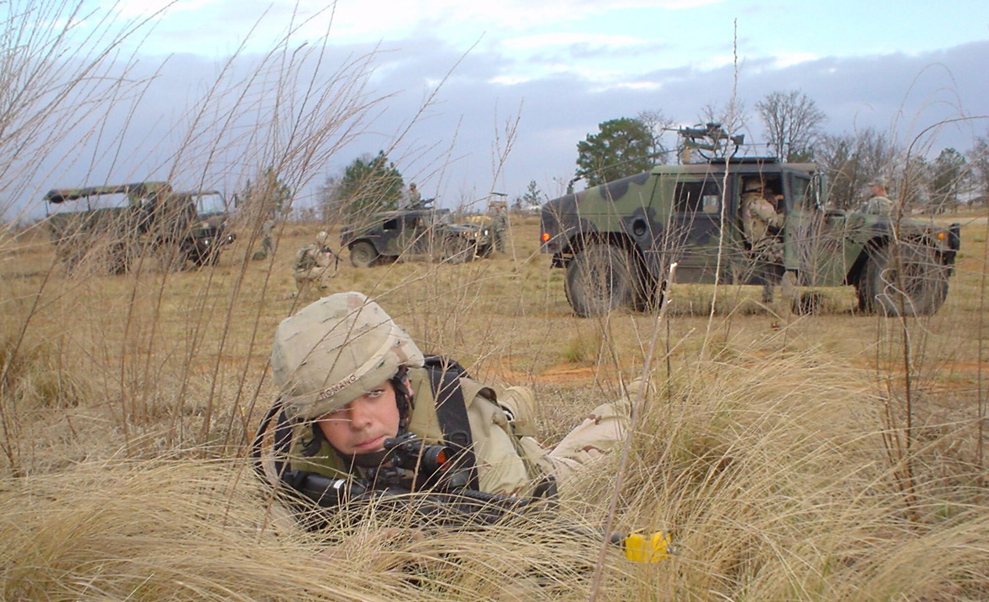 Senior Airman Tom Romano guards a convoy's perimeter during combat training at Fort Bragg, N.C., on Monday, March 27, 2006, before deploying to Afghanistan.  Airman Romano volunteered for a year-long deployment with the Bagram Provincial Reconstruction Team.  He is a security forces specialist from Minot Air Force Base, N.D. (U.S. Air Force photo/Capt. Mark D. Gibson)