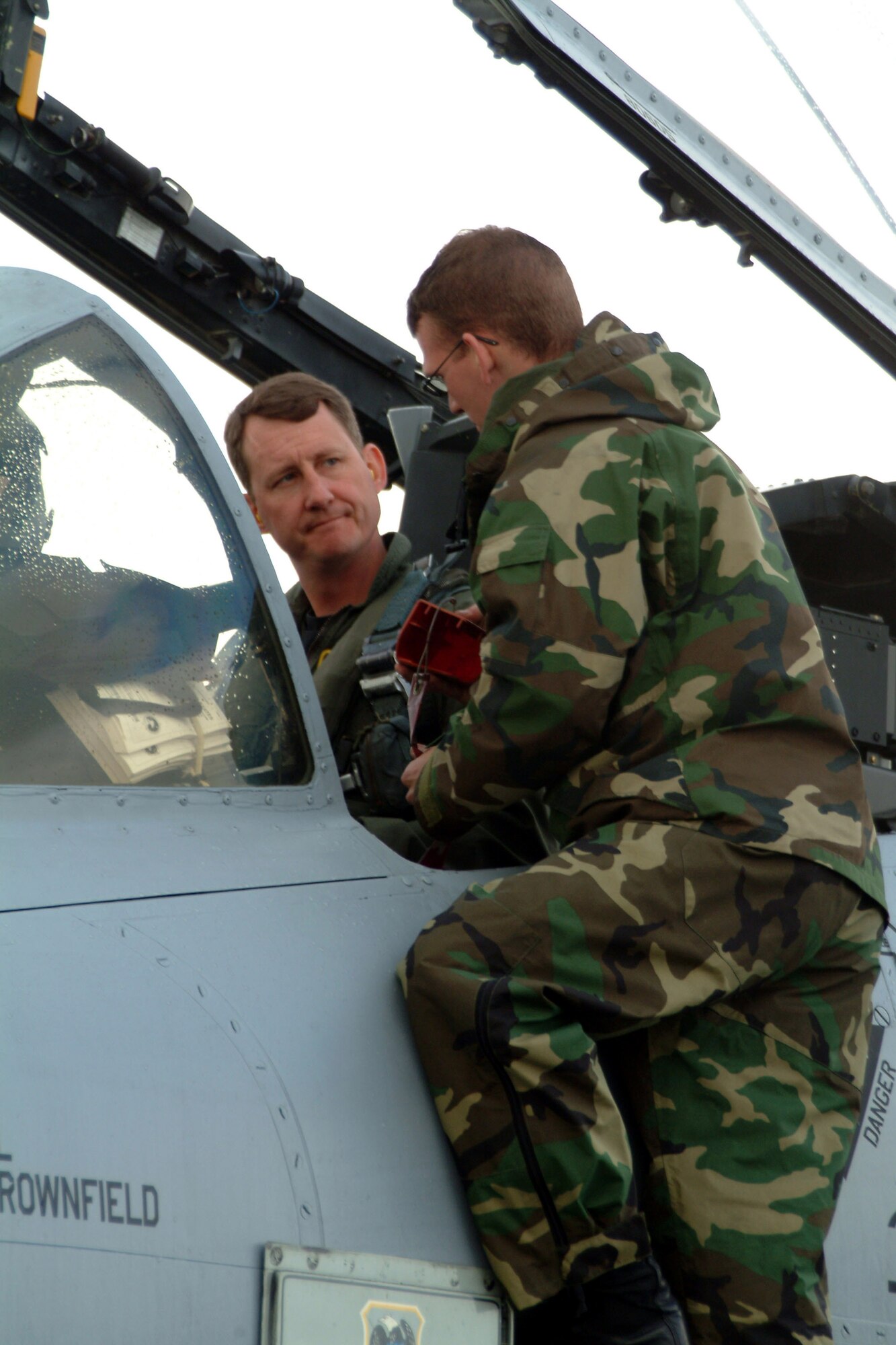 Lt. Col. Ronald Hankes, left, the flight lead for the 303rd Fighter Squadron's Hawgsmoke team for 2006, talks with crew chief, Senior Airman Steve Powell, at an exercise at McChord Air Force Base, Wash., in May 2005.  Colonel Hanks, along with team mates Lt. Col. James Mackey, Maj. Stephen Nester and Capt. Brian Leiter, brought the title of Hawgsmoke champions to the 442nd Fighter Wing at Whiteman AFB, Mo. Hawgsmoke is an A-10 bombing and gunnery competition, held every two years, to test A-10 pilots and aircraft in providing close air support. This is the first time the Air Force Reserve's 442nd FW has won the competition, which was held at Davis-Monthan AFB, Ariz., March 22 to 25.