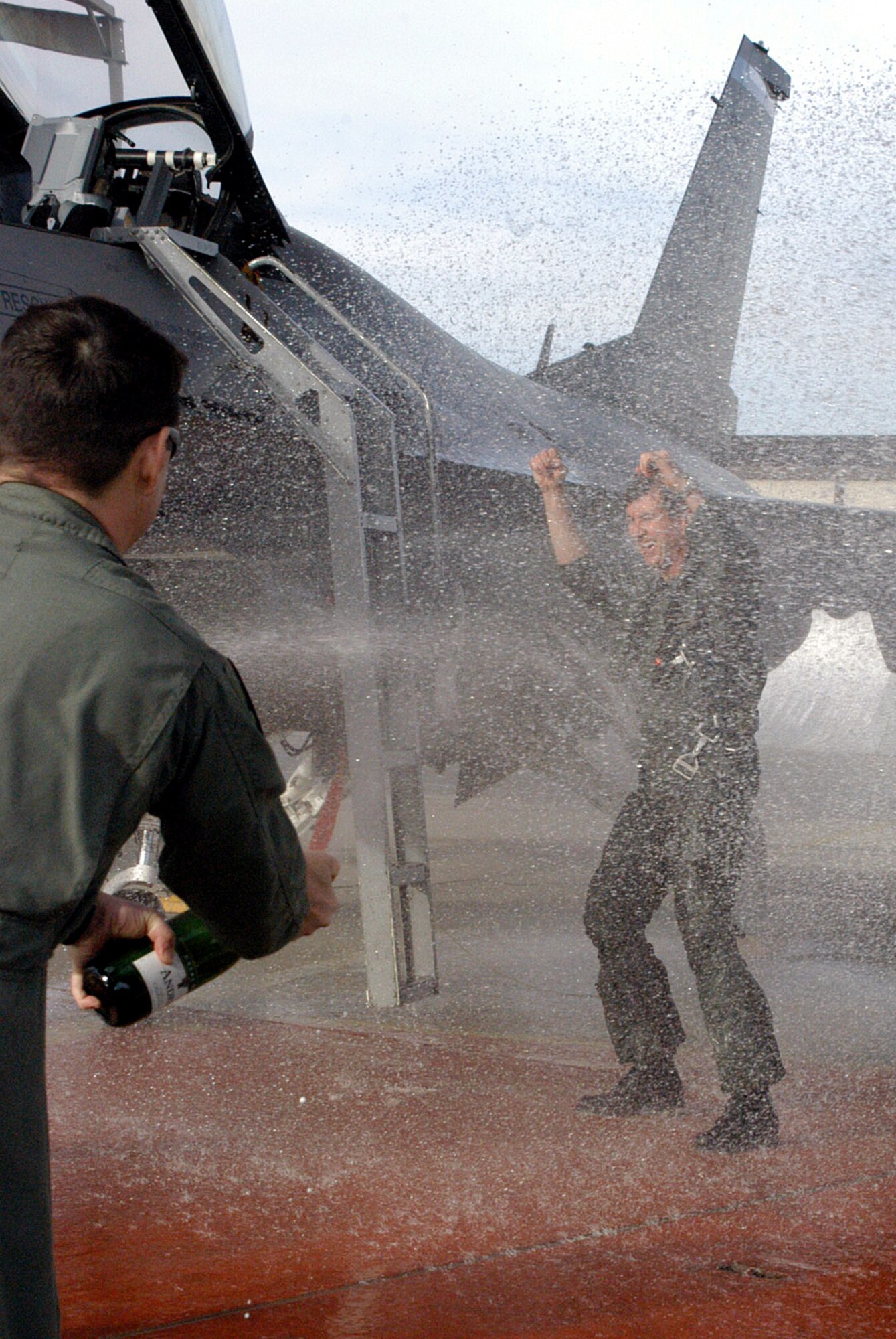 Col. Bill Schauffert, right, 301st Fighter Wing vice commander, gets a well-deserved champagne shower from Lt. Col. Steve Olmos, 457th Fighter Squadron pilot, following the colonel's fini flight in January. Colonel Schauffert is being reassigned as the Mobilization Assistant to the 19th Air Force commander at Randolph Air Force Base, Texas.  The new vice commander will be Col. Tommy Williams. (Photo by Tech. Sgt. Julie Briden-Garcia, Public Affairs)