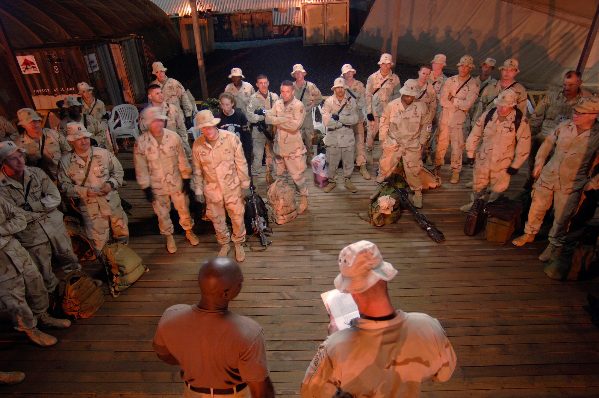 Roll call on the evening of Wednesday, March 15, 2006, had Soldiers of the 864th Engineering Battalion at Fort Lewis, Wash., and 82nd Infantry, 2nd Airborne, Fort Bragg, N.C., calling out "Here, first sergeant" as their names are read. Following this, they are given their "rules of engagement" for their stay at Manas Air Base, Kyrgyzstan. (U.S. Air Force photo/Master Sgt. Lance Cheung)