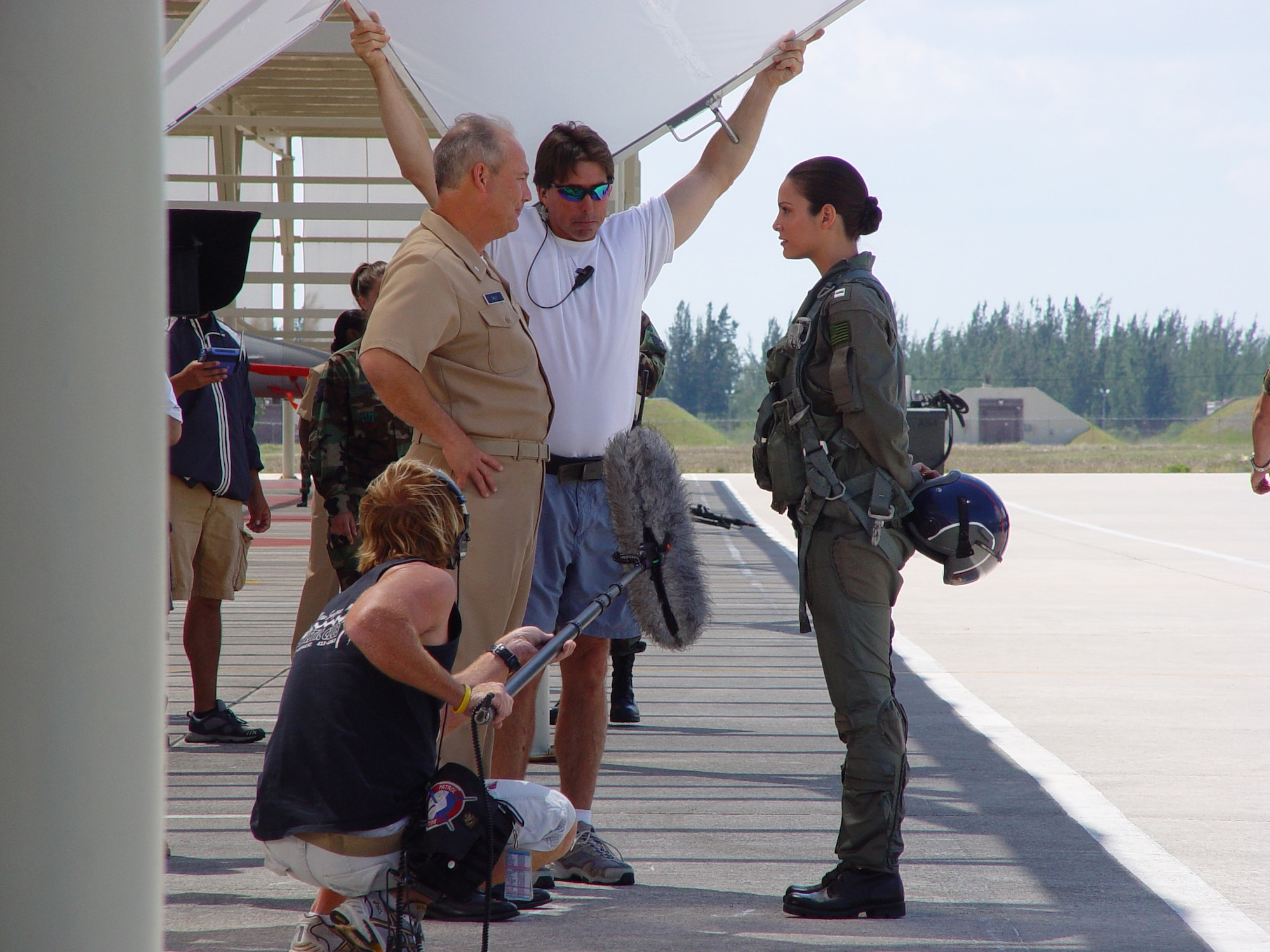 Miss Universe 2001 Denise Quinones, right, cuts a scene on the aircraft ramp here at Homestead Air Reserve Base, Fla. on March 27. She plays the role of Rachel Starling, an F-18 pilot and potential love interest of "Aquaman." The Warner Brothers crew shot scenes at five locations on the reserve base. (US Air Force Reserve Photo by Lisa M. Macias)