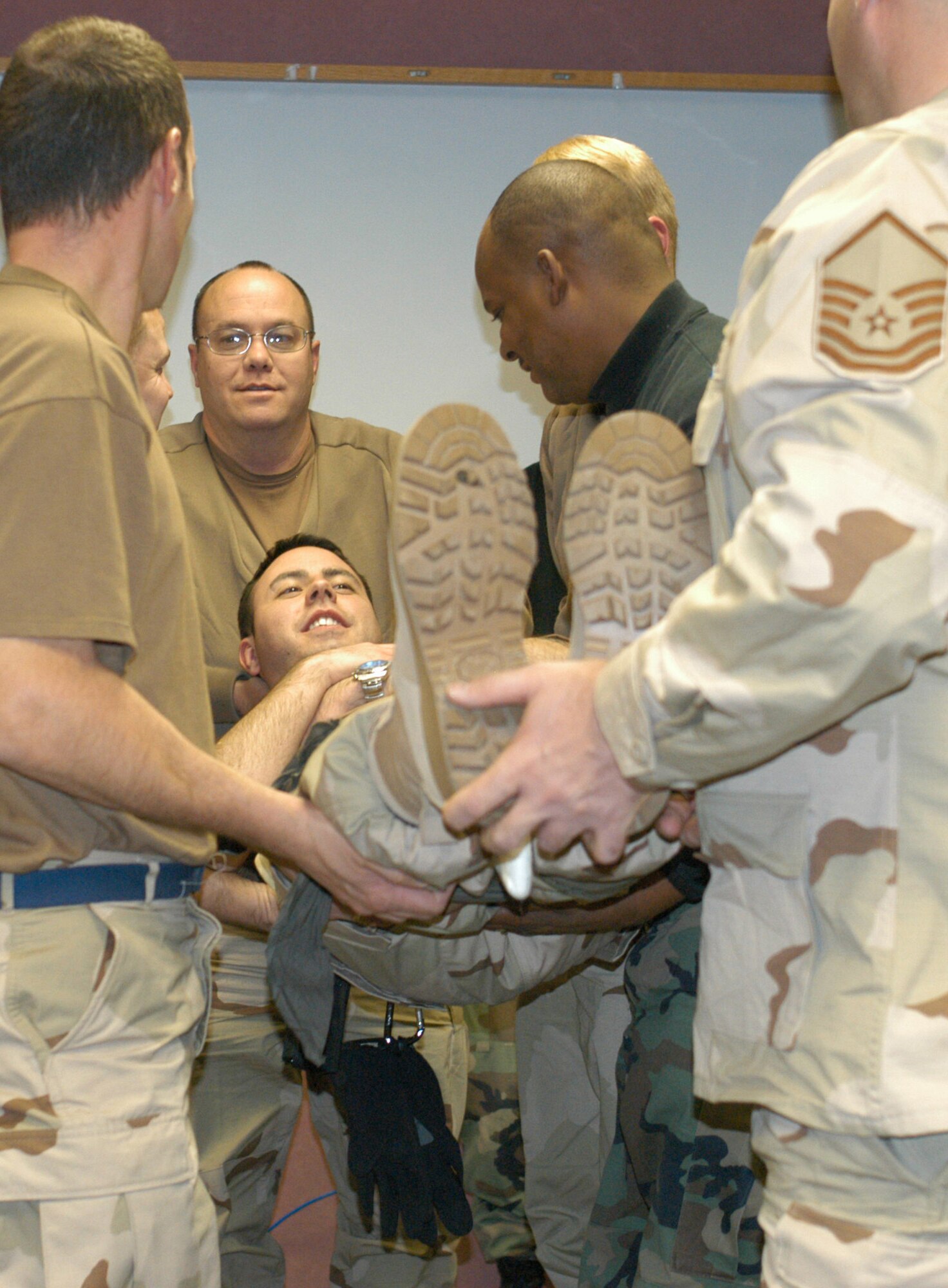 Members of the 32nd Aerial Port Squadron undergo self-aid and buddy care training  in preparation for their January deployment to Manas, Kyrgyzstan.