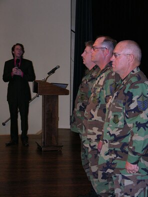 SEYMOUR JOHNSON AIR FORCE BASE, N.C. -- American Idol star, Clay Aiken, sings the national anthem during a retirement ceremony for three 916th Air Refueling Wing civil engineers. Master Sgts. Bennett, Cooper and Thompson retired from the Air Force Reserve unit in March.