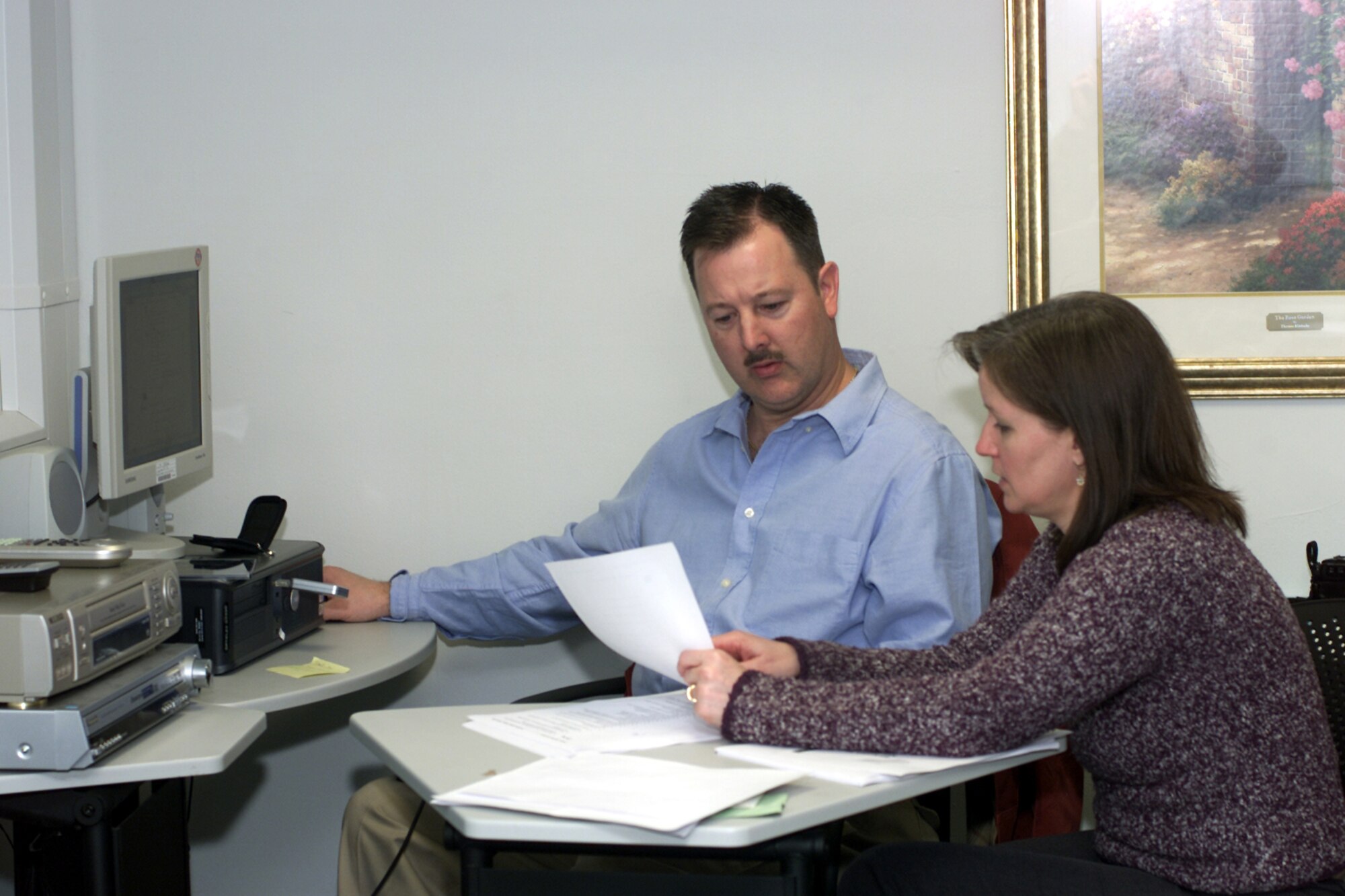 ROYAL AIR FORCE ALCONBURY, England -- Bonnie Peterson, tri-base key spouse for the Joint Analysis Center, and Master Sgt. Roger Bullis, Air Combat Command Family Matters superintendent, work on final changes to the Key Spouse Program training modules March 16 at the family support center here.