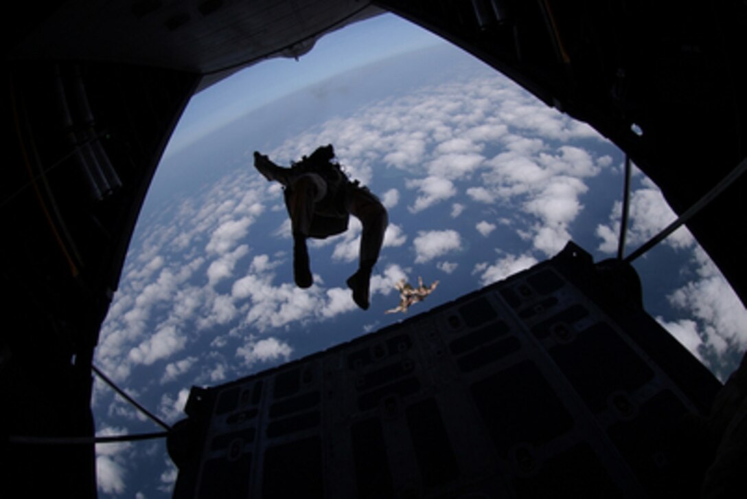 An Air Force pararescueman does a back flip out as he exits a U.S. Air Force HC-130P Hercules in a parachute jump over the Gulf of Tadjoura, Djibouti, on March 28, 2006. The pararescueman is attached to the 304th Expeditionary Rescue Squadron deployed to the Horn of Africa from Portland, Ore. 