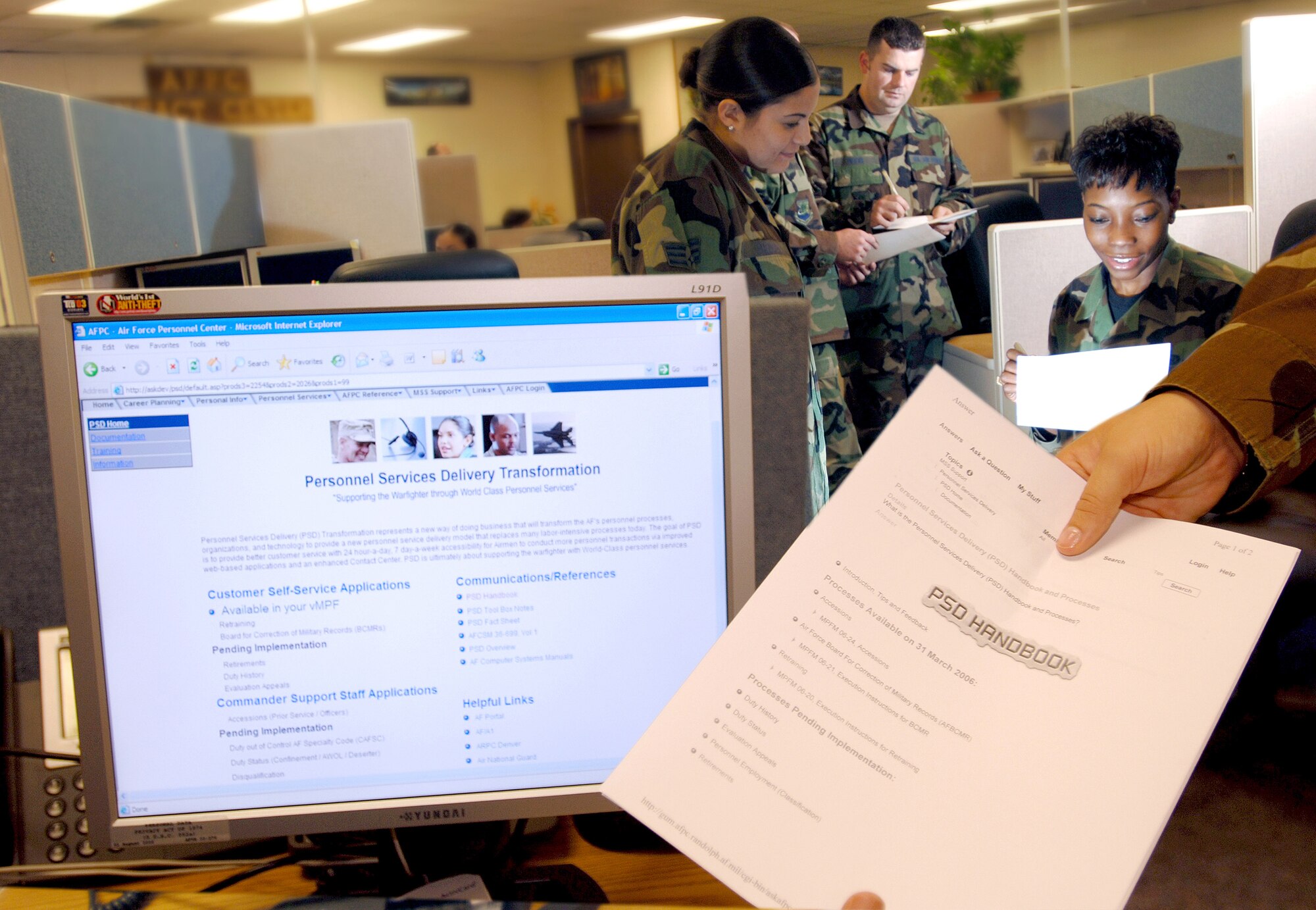 Senior Airman Ashley Thomas and Staff Sgts. Jason Picos and Shamonn Castor of the Air Force Personnel Center's contact center discuss the implementation of the new Personnel Service Delivery system at Randolph Air Force Base, Texas, Friday, March 31, 2006.(U.S. Air Force photo illustration/Tech. Sgt. Cecilio Ricardo Jr.)