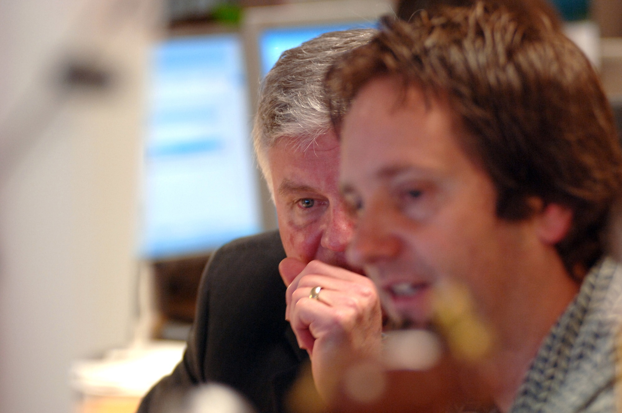 Roger Blanchard, deputy A1, takes a customer call alongside Tim Moore, contact center agent, to discuss the use of the new Personnel Service Delivery System at Randolph Air Force Base, Texas, Friday, March 31, 2006. (U.S. Air Force photo/Tech. Sgt. Cecilio Ricardo Jr.)