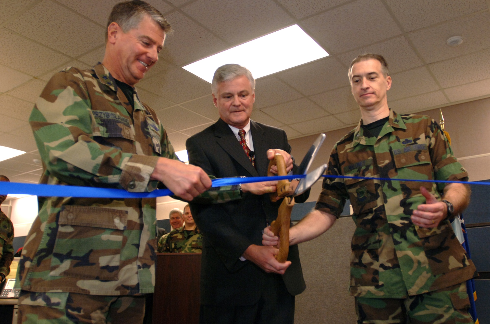 Left to right, Maj. Gen. Tony Przybyslawski, Air Force Personnel Center commander, Roger Blanchard, deputy A1, and Col. Michael Maloney, AFPC director of personnel, cut the ribbon to symbolize the operational beginning of the new Personnel Service Delivery System at Randolph Air Force Base, Texas, on Friday, March 31, 2006. (U.S. Air Force photo/Tech. Sgt. Cecilio Ricardo Jr.)