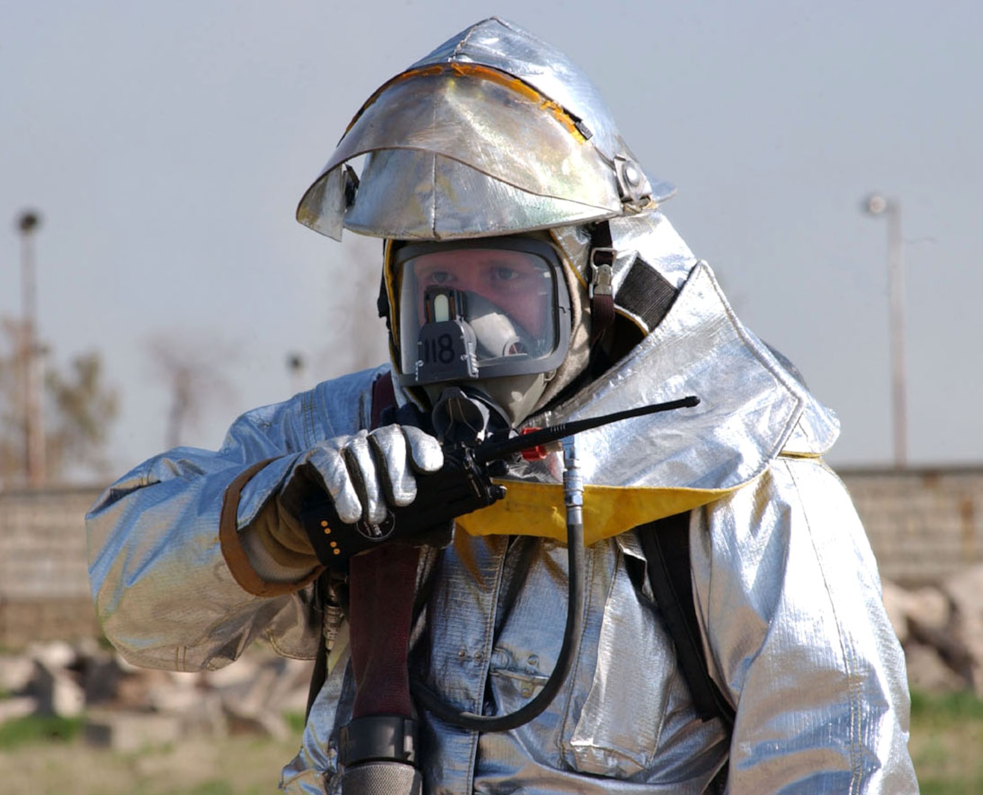 Staff Sgt. Jimmy Cole keeps in contact with response teams at the site of a suspected chemical lab during an exercise at Kirkuk Air Base, Iraq. Sergeant Cole is a crash truck crew chief with the 506th Expeditionary Civil Engineer Squadron fire department. (U.S. Air Force photo/Airman 1st Class JoAnn White)                   