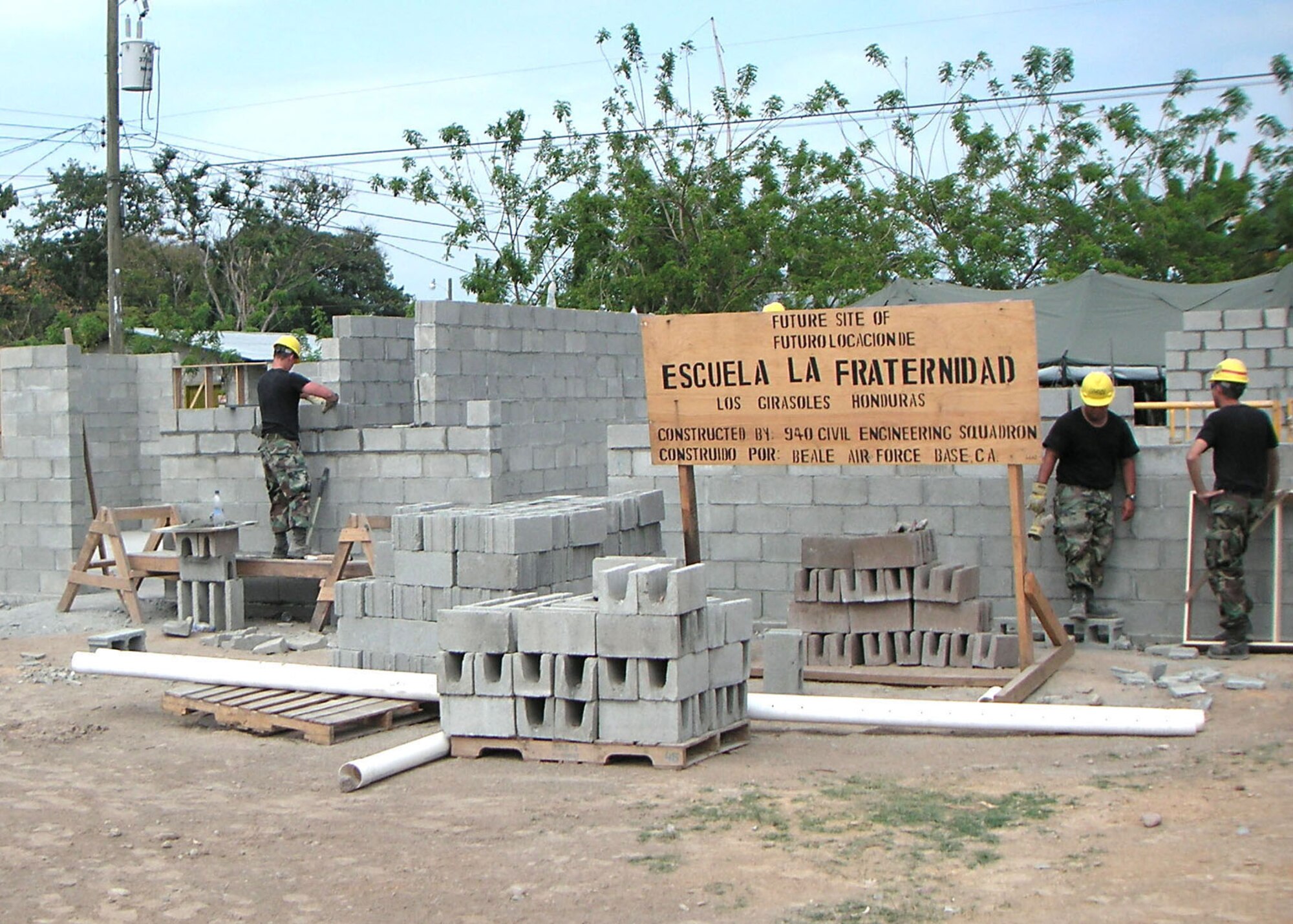 3/21/2006 - LOS GIRASOLES, Honduras -- Air Force Reservists from the 940th Civil Engineer Squadron build a school here: from left: Staff Sgt. John Ertel, heavy equipment craftsman; Staff Sgt. Jason  Sanchez and SSgt Andrew Butler, both Engineer assistants.  New Horizons 2006-Honduras is a joint training exercise between the U.S. military and the Honduran government that will improve the quality of life for the local people. When the exercise concludes in May, the Joint Task Force here will have constructed a maternity clinic, four schools and provided free medical care at 14 different locations in and around La Ceiba. (U.S. Air Force photo by Master Sgt. William A. Smith, Jr.)