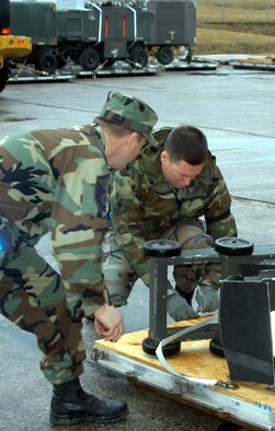 Advon team Chief Master Sgt. Guy Plante and Master Sgt. Brent Marsh, 944th Fighter Wing, start the cargo unloading process to prepare for Brilliant Arrow Operations. More than 150 members of the 301st and 944th Fighter Wings deployed in support of "Brilliant Arrow," the air component of maritime, land and air NATO exercises going on in the region. The exercises are the final preparation phase before these three essential components of the NATO Response Force come together for the first time in the spring for the NRF live exercise "Steadfast Jaguar" off the west coast of Africa. (U.S. Air Force Reserve photo by Tech. Sgt. Barbara Plante)                                                     
