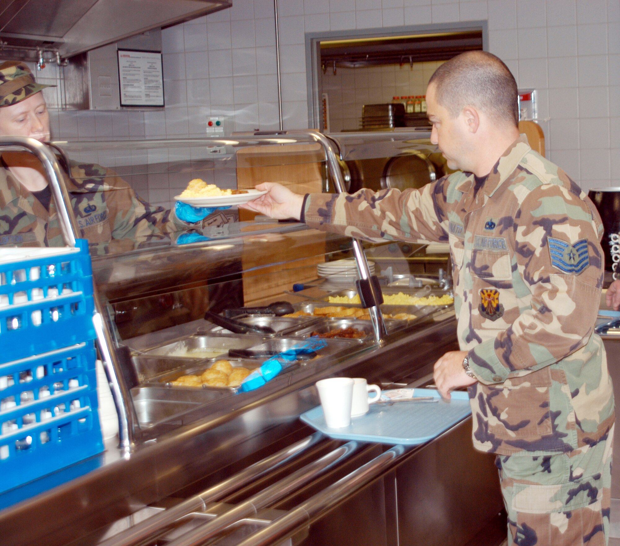 Tech. Sgt. Matt Bennato, a reservist with the 944th Fighter Wing, is the first in line to get breakfast at the Jet Blast while deployed to Germany in support of exercise "Brilliant Arrow." The deployed services personnel have served more than 600 hot meals. (U.S. Air Force Reserve photo by Tech. Sgt. Barbara Plante)