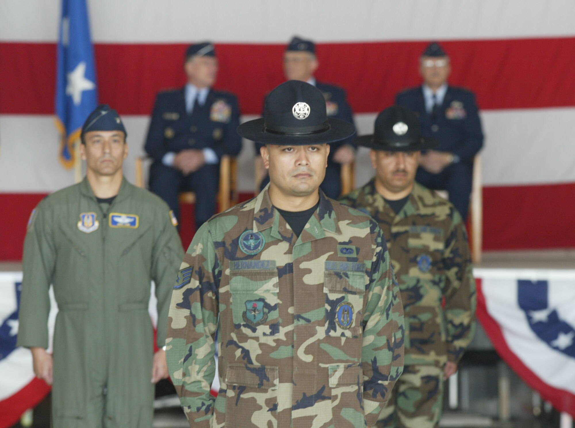 From the left, Col. Mike Kim, vice commander of 22nd Air Force and commander of the troops, along with training instructors from the 37th Training Wing, Lackland Air Force Base, Texas, await the next command for the troop formations at the Change of Command ceremony.