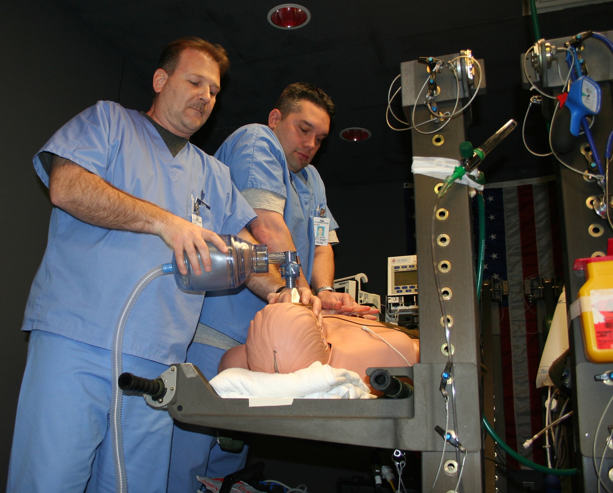 Tech. Sgt. Alfred Slusher (left) and Master Sgt. Scott Luff provide Cardio Pulmonary Resuscitation (CPR) to a mannequin that is connected to a computer to monitor if the procedures are correct. (U.S. photo by photo by Maj. Ted Theopolos)