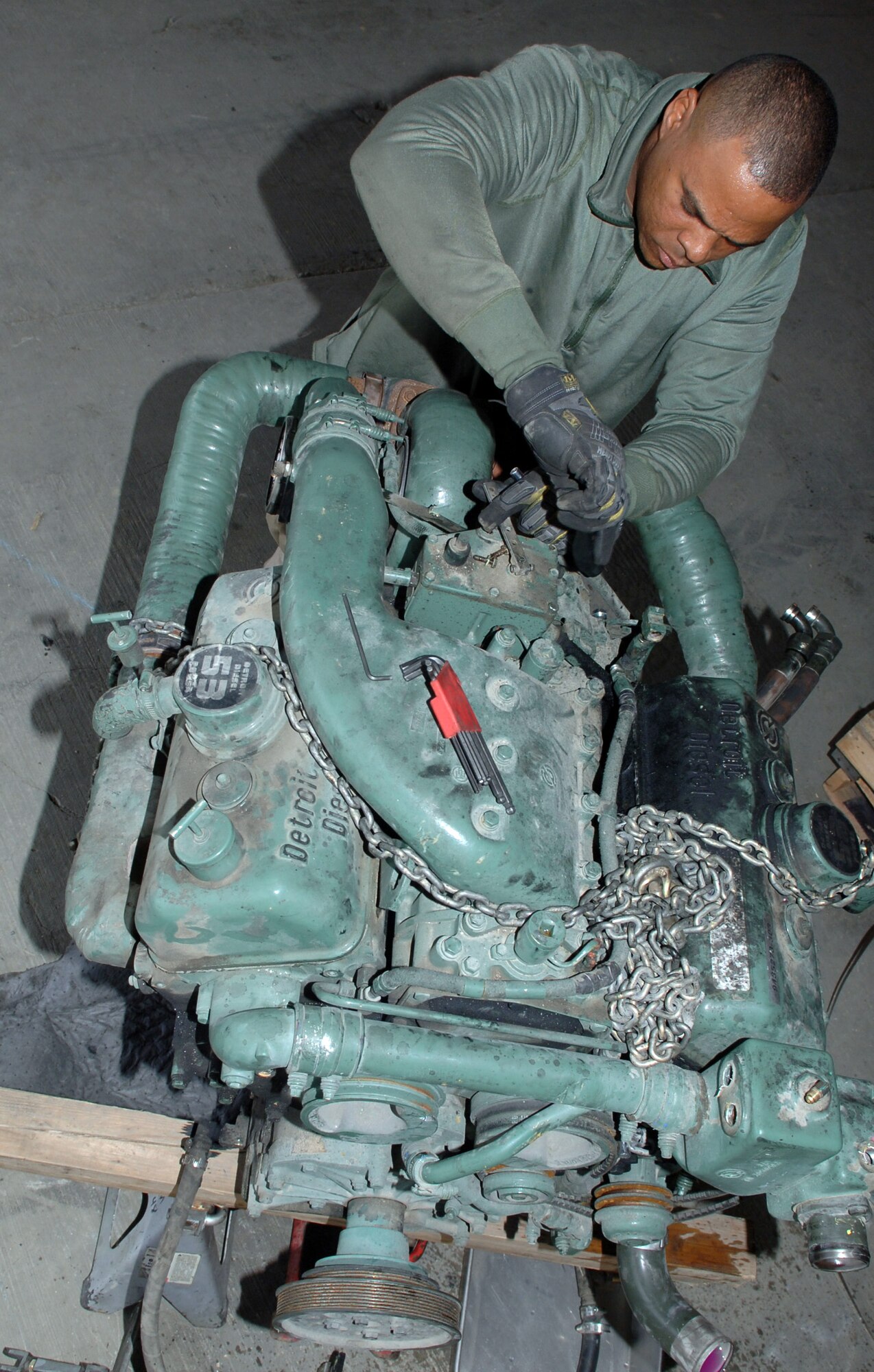 Staff Sgt. Andre McDonald removes oil fittings from an old 60K aircraft loader engine. Sergeant McDonald is deployed to the 455th Logistic Readiness Squadron from Aviano Air Base, Italy. (U.S. Air Force photo/Staff Sgt. Jennifer Redente)
