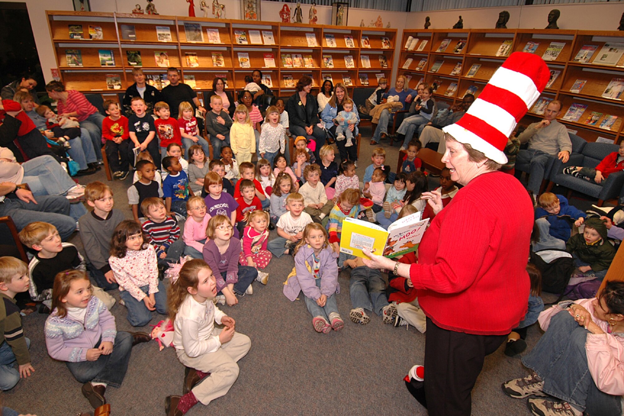 Library Director, Sandy Koontz  entertains Scott children as she reads a Dr. Suess book at the Base Library during a celebration of Dr. Suess' birthday.