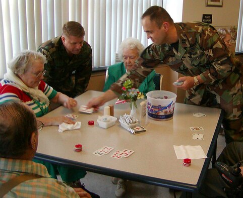 Capt. Michael Wall, 375th Logistics Readiness Squadron and Chief Master Sgt. Carl Hunsinger, 375th Airlfit Wing command chief master sergeant, facilitate a game of blackjack during their visit to the Quincy Veterans' Home.