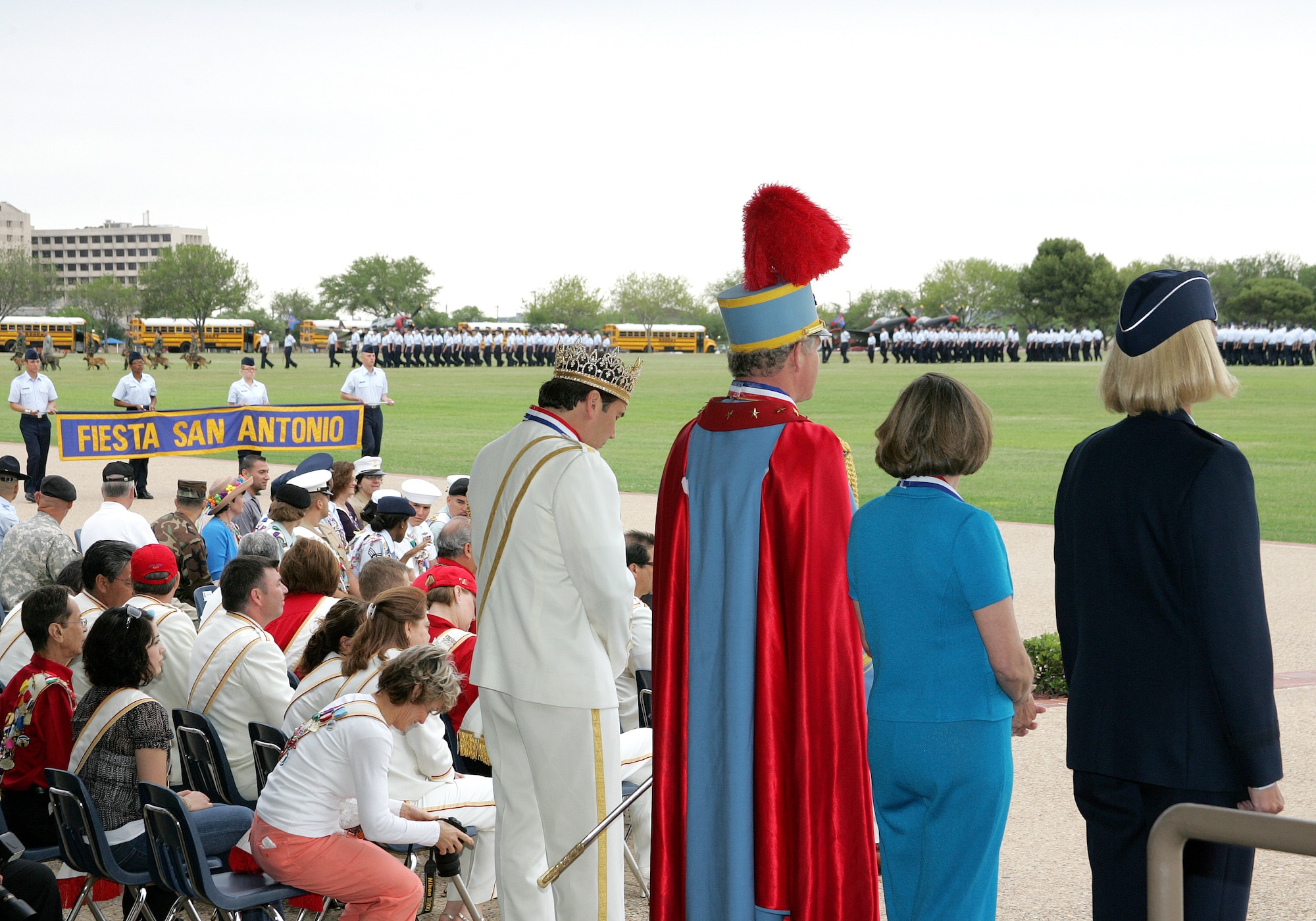 Fiesta royalty, including El Rey Feo, Johnny Gabriel; King Antonio LXXIV, Rick Shaw; Fiesta San Antonio Commission president, Mary West Traylor; along with Brig. Gen. Mary Kay Hertog, 37th Training Wing commander, review a parade of flights at Lackland Air Force Base, Texas, on Wednesday, April 26, 2006. The military parade was one of the many events held during Fiesta, a 10-day celebration to honor the memory of the heroes of the Alamo and the Battle of San Jacinto in 1836. (U.S. Air Force photo/Robbin Cresswell) 
                          