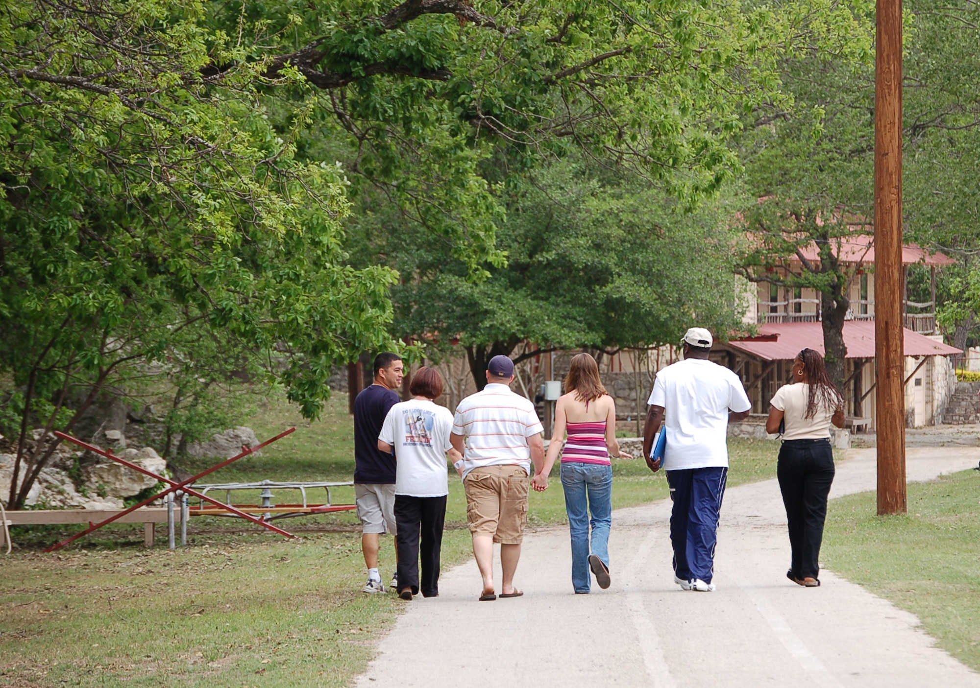 (Left to right) Staff Sgt. Jerry Desrochers chats with his wife, Senior Airman Cheryl Desrochers, Senior Airman Aaron and Mellissa Childs and Master Sgt. Don and Tina Taylor as they walk to lunch at the at the Heart of the Hill Camp in Hunt, Texas, on Saturday, April 22, 2006. The three couples had just finished a group session on family separation. All three couples, from Seymour Johnson Air Force Base, N.C., attended a retreat April 20 to 27 hosted by the Military, Veteran and Family Assistance Foundation. The retreat helps couples reconnect after the military spouse returns from a deployment. (U.S. Air Force photo/Louis A. Arana-Barradas)