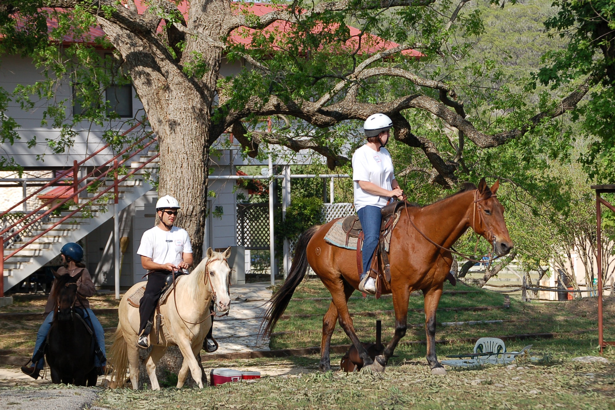A military couple heads back to the stable after an afternoon of horseback riding during a retreat at the Heart of the Hills Camp in Hunt, Texas, on Saturday, April 22, 2006. The retreat , hosted by the Military, Veteran and Family Assistance Foundation, helps couples reconnect after the military spouse returns from a deployment. (U.S. Air Force photo/Louis A. Arana-Barradas) 
