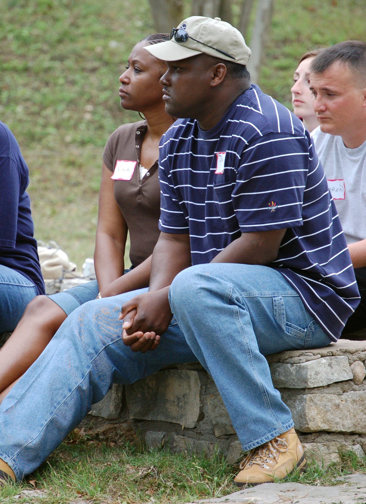 Nina and Master Sgt. Don Taylor (front) and Mellissa and Senior Airman Aaron Childs attend a Native American spiritual ceremony during a retreat at the Heart of the Hills Camp in Hunt, Texas, on Saturday, April 22, 2006. The retreat, hosted by the Military, Veteran and Family Assistance Foundation, helps couples reconnect after the military spouse returns from a deployment. (U.S. Air Force photo/Louis A. Arana-Barradas) 


