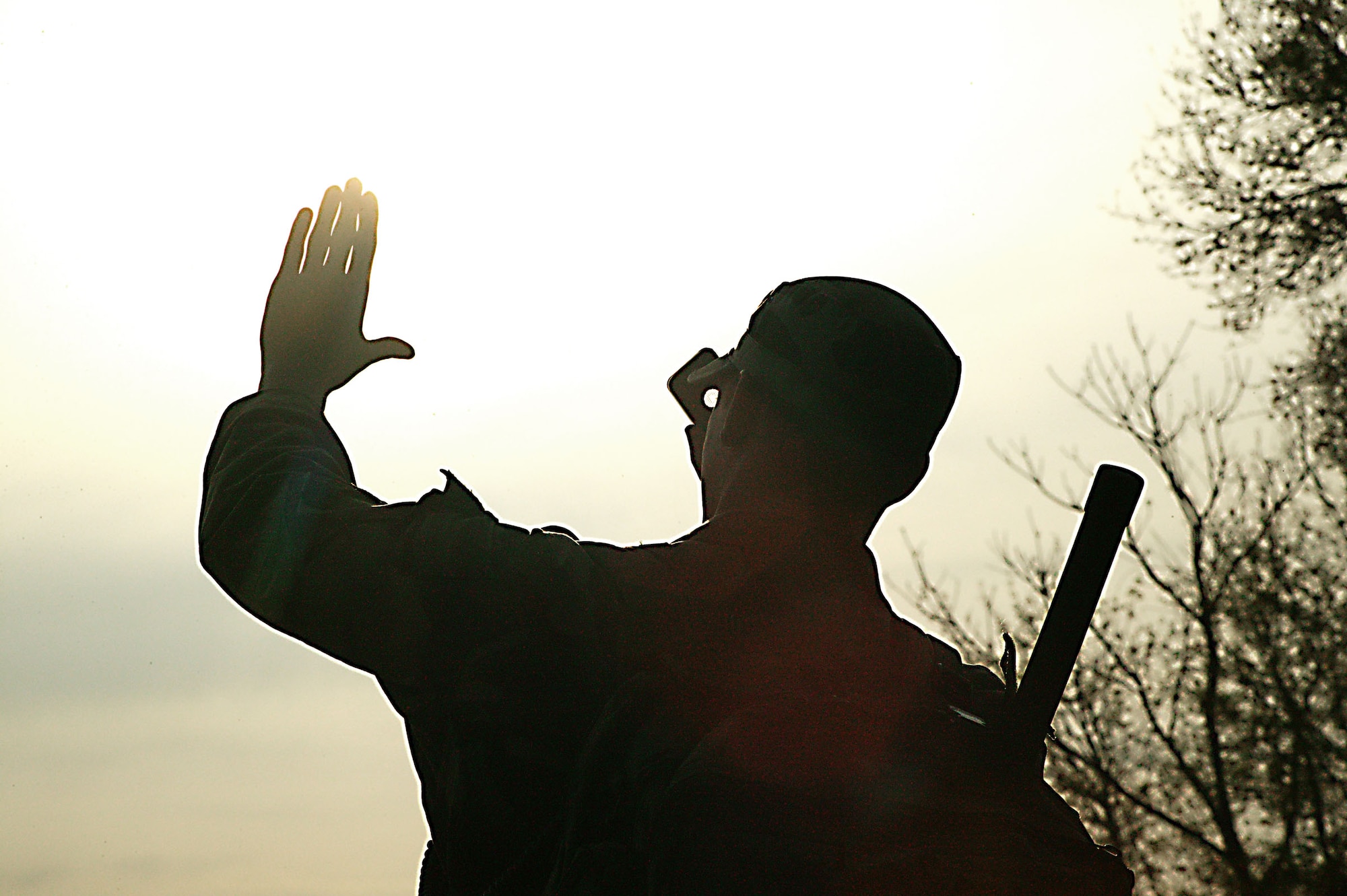 Airman 1st Class Jonathan Hughs, a fighter duty technician with the 682nd AIr Support Operations Squadron, uses a mirror to signal to an A-10 Aircraft.  (U.S. Air Force Photo/Senior AIrman John Gordinier)