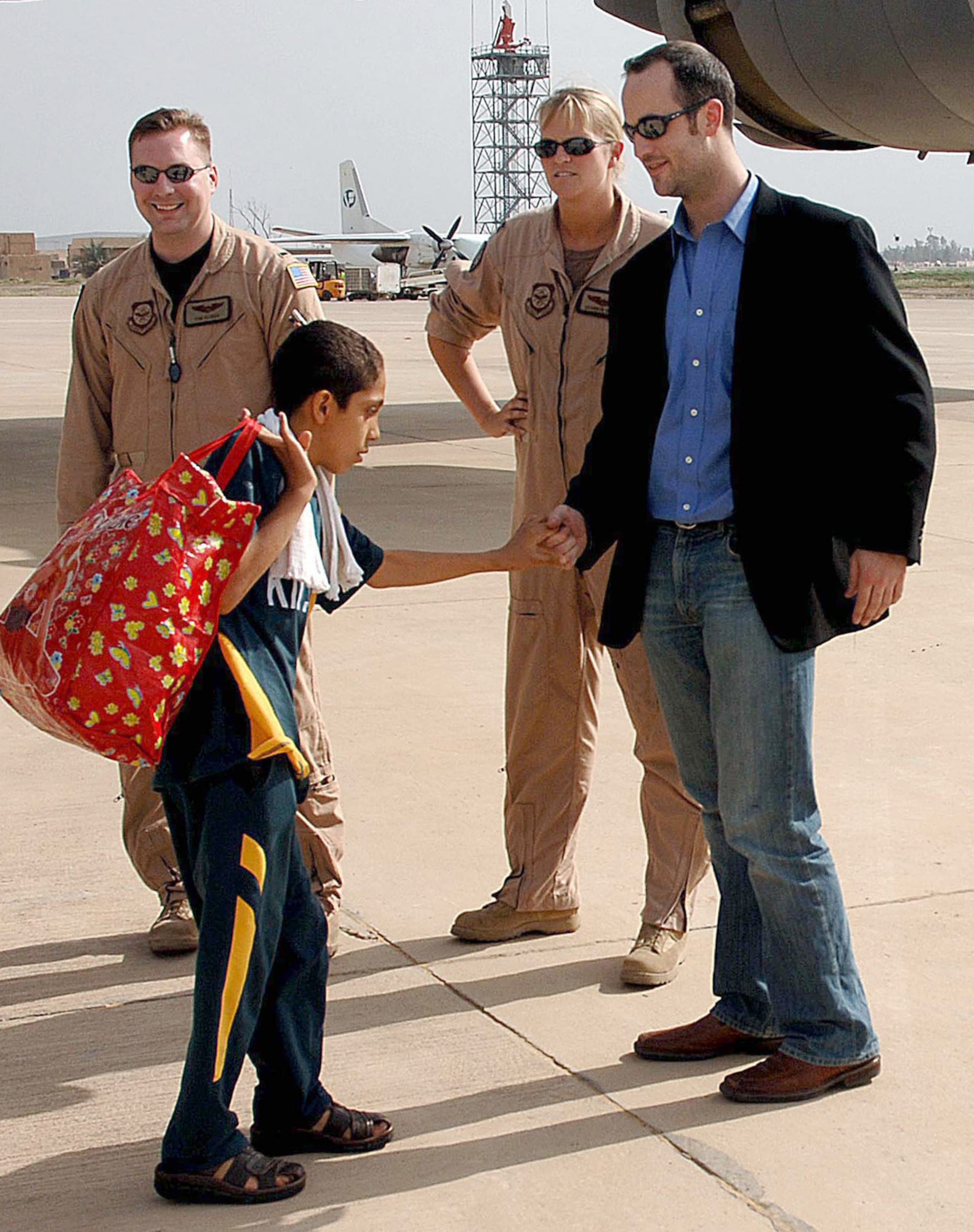 An Iraqi boy thanks Chris Anderson of Operation Smile upon arriving at Baghdad International Airport, Iraq, on Saturday, April 29, 2006. Operation Smile provides corrective surgery for cleft palates and cleft lips. The program provided surgery in Amman, Jordan, to more than 100 Iraqi children. They were flown back to Iraq on an Air Force C-17 Globemaster III. (U.S. Air Force photo/Master Sgt. Will Ackerman)