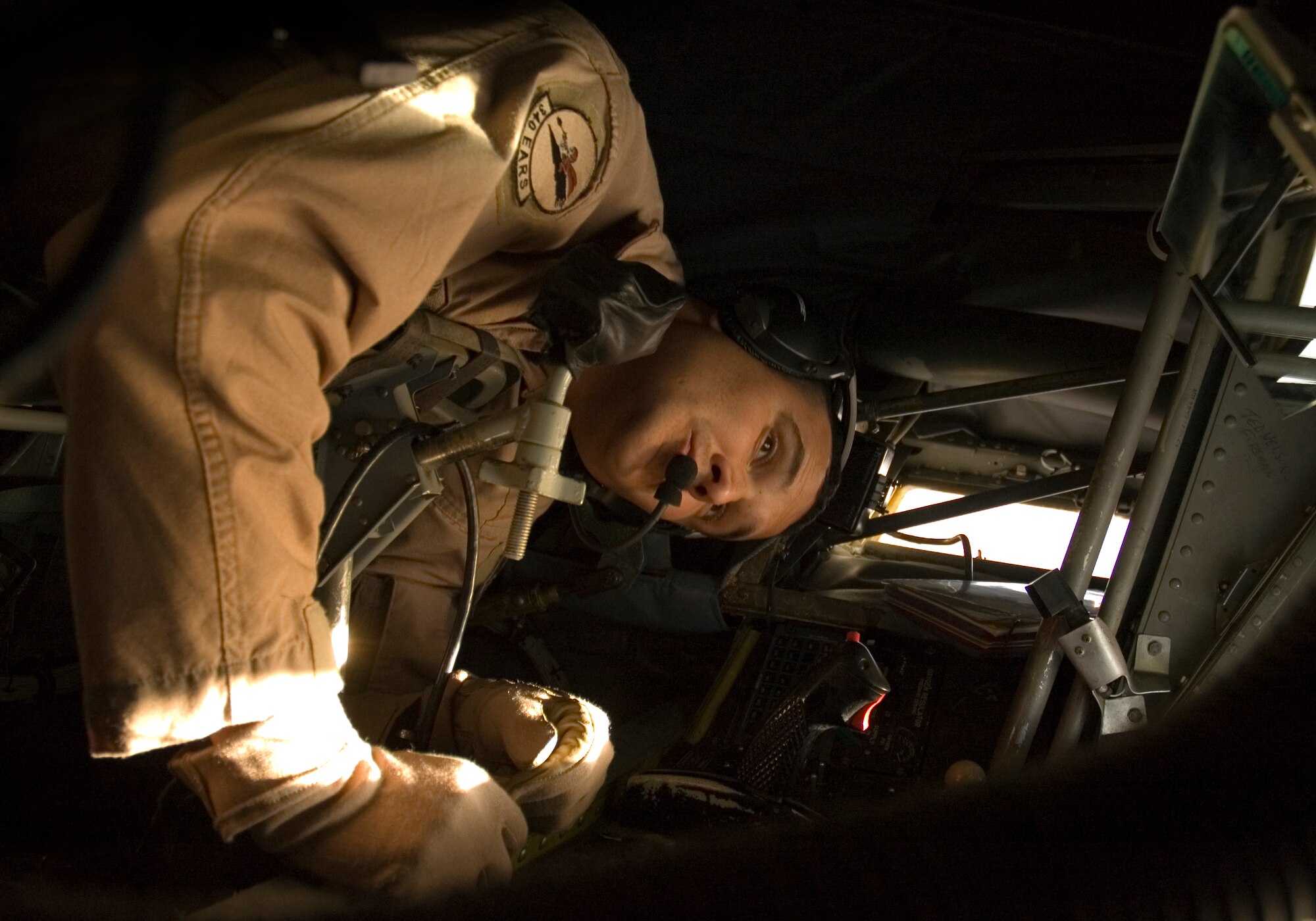 Staff Sgt. Anthony Krisher, 340th Expeditionary Air Refueling Squadron boom operator, uses mirrors in the boom pod of a KC-135R Stratotanker to check the air refueling boom before servicing aircraft over Iraq Tuesday, April 18. Sergeant Krisher is deployed from the 434th Air Refueling Wing at Grissom Air Reserve Base, Ind., and is a former KC-135 crew chief. (U.S. Air Force photo/Senior Airman Mark R.W. Orders-Woempner)