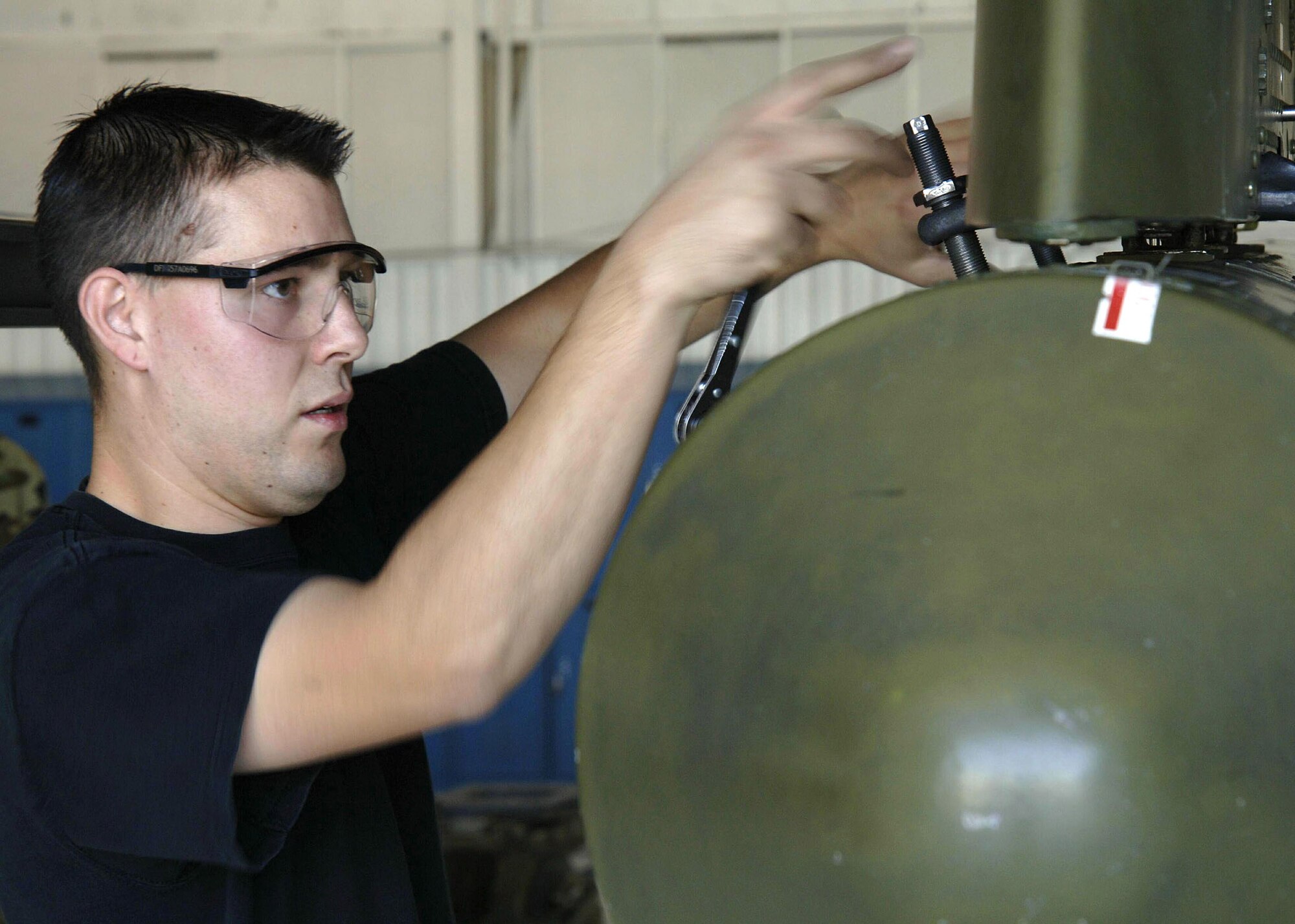 Senior Airman Joseph Harrison adjusts a flare dispenser during the 355th Wing "Load Crew of the Quarter" competition on Thursday, April 27, 2006, at Davis-Monthan Air Force Base, Ariz. The 354th, 357th and 358th Aircraft Maintenance Units are competing for the title. Airman Harrison is with the 357th AMU. (U.S. Air Force photo/Senior Airman Christina D. Ponte)