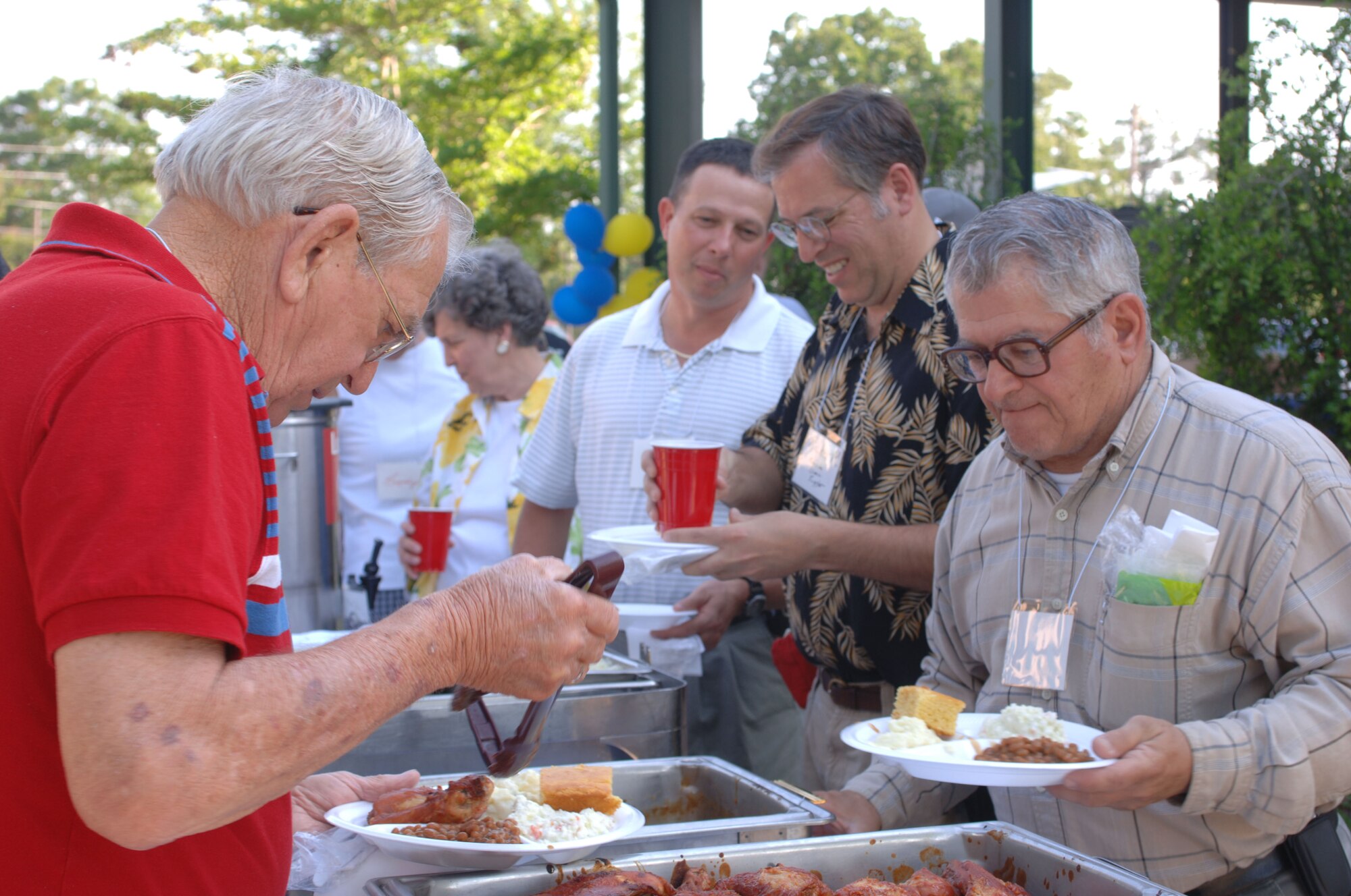 Volunteers fill up their plates Monday at the volunteer appreciation barbecue.  (U.S. Air Force Photo/Airman Matthew Davis)